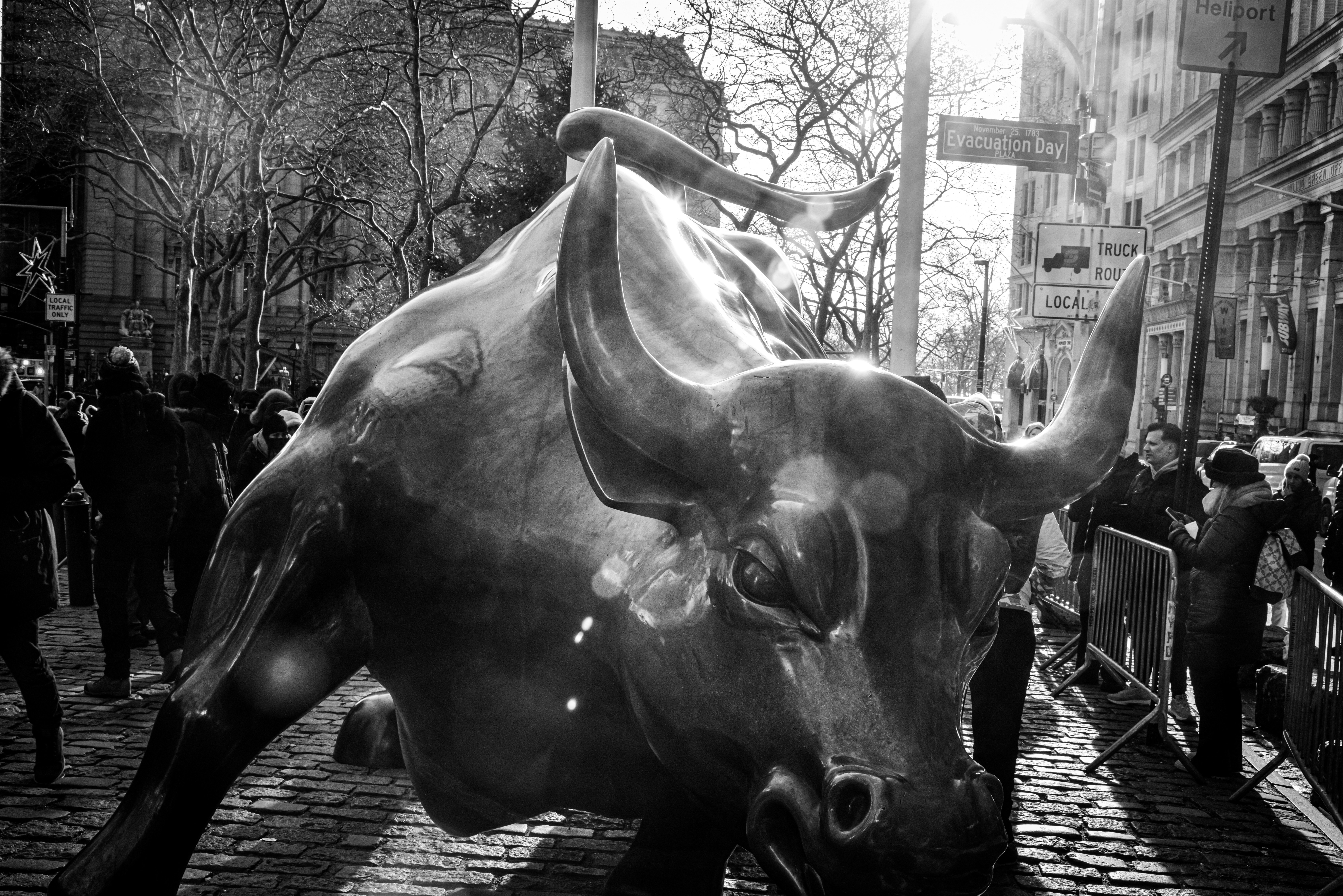 a statue of a bull on a city street