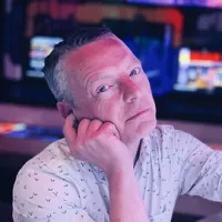 Trevor Davey Headshot in white shirt with blurred background