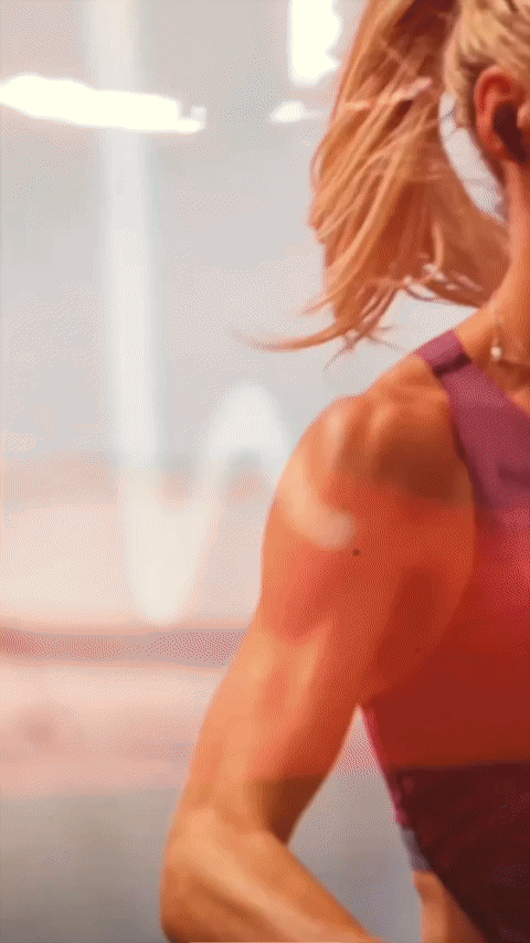 Three models standing in a wheat field, wearing beige suits.
