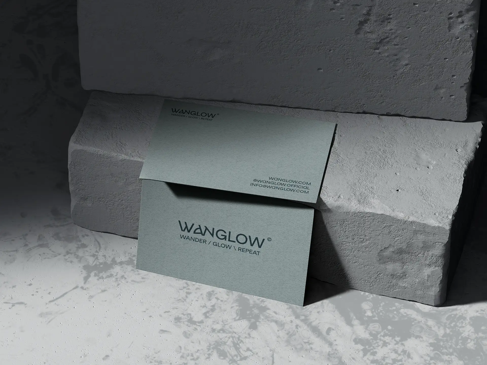 Business card design for Wanglow men's skincare brand showing logo and brand identity on textured paper