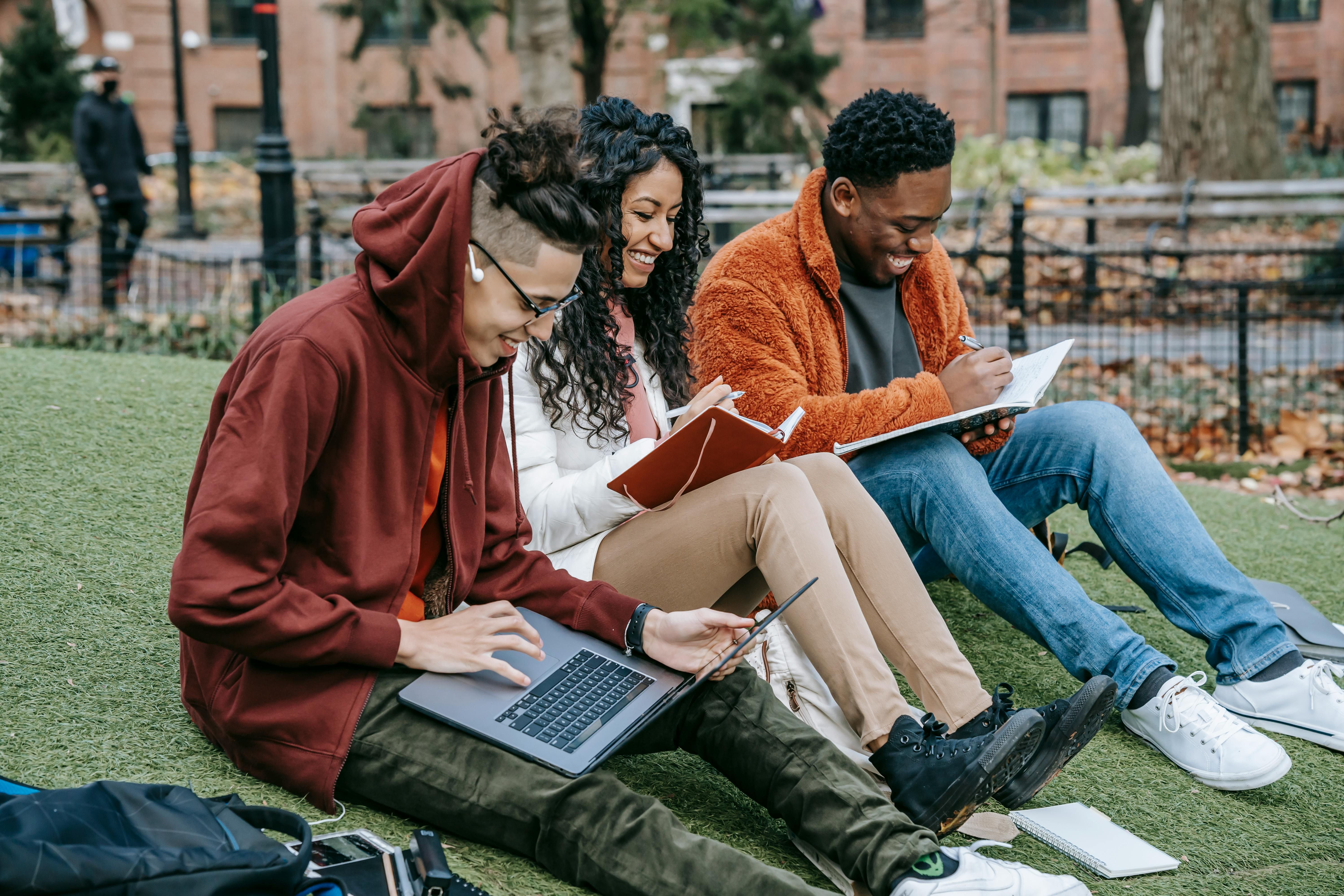 College students working on homework and have conversation. They feel safe because of the mobile safety technology that SaferMobility has supplied them.