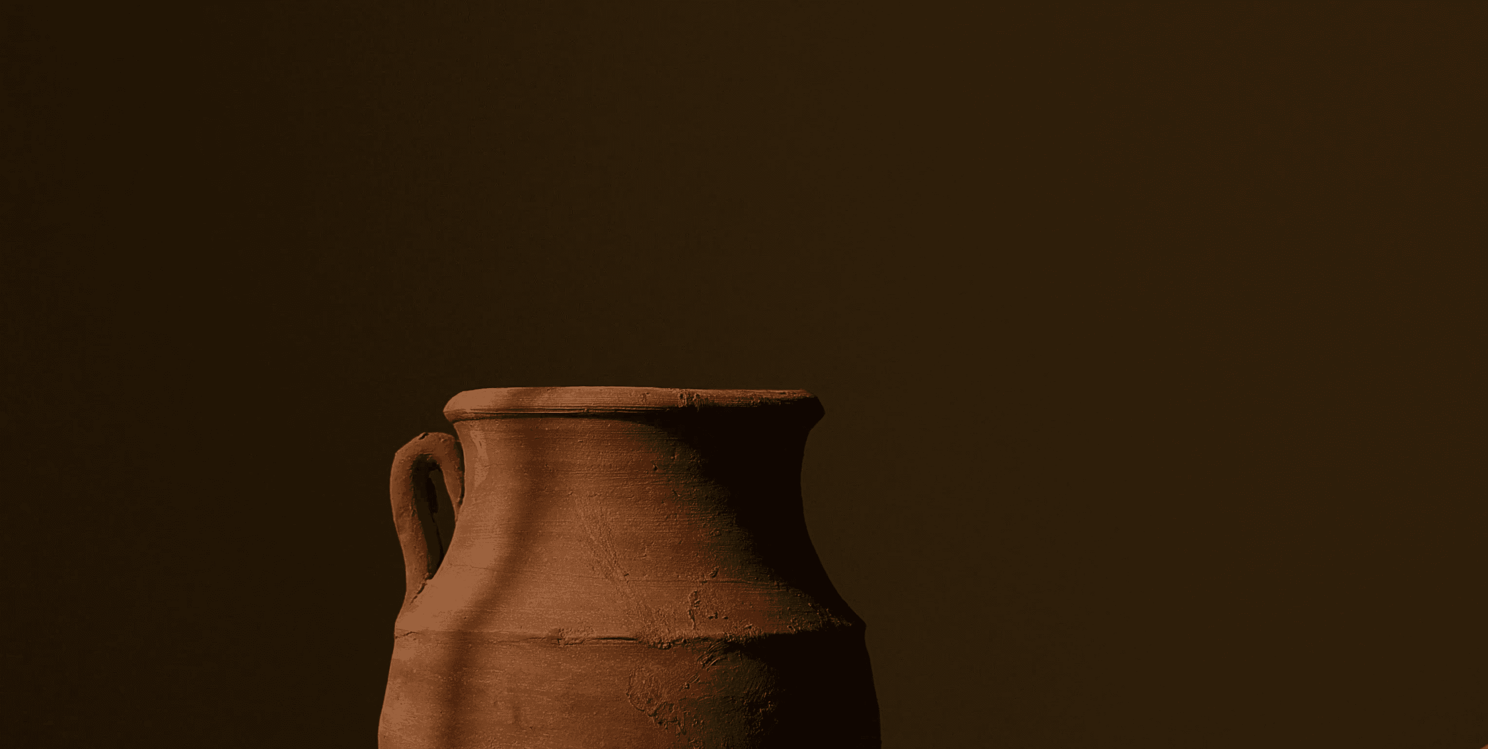 brown ceramic vase on brown wooden table