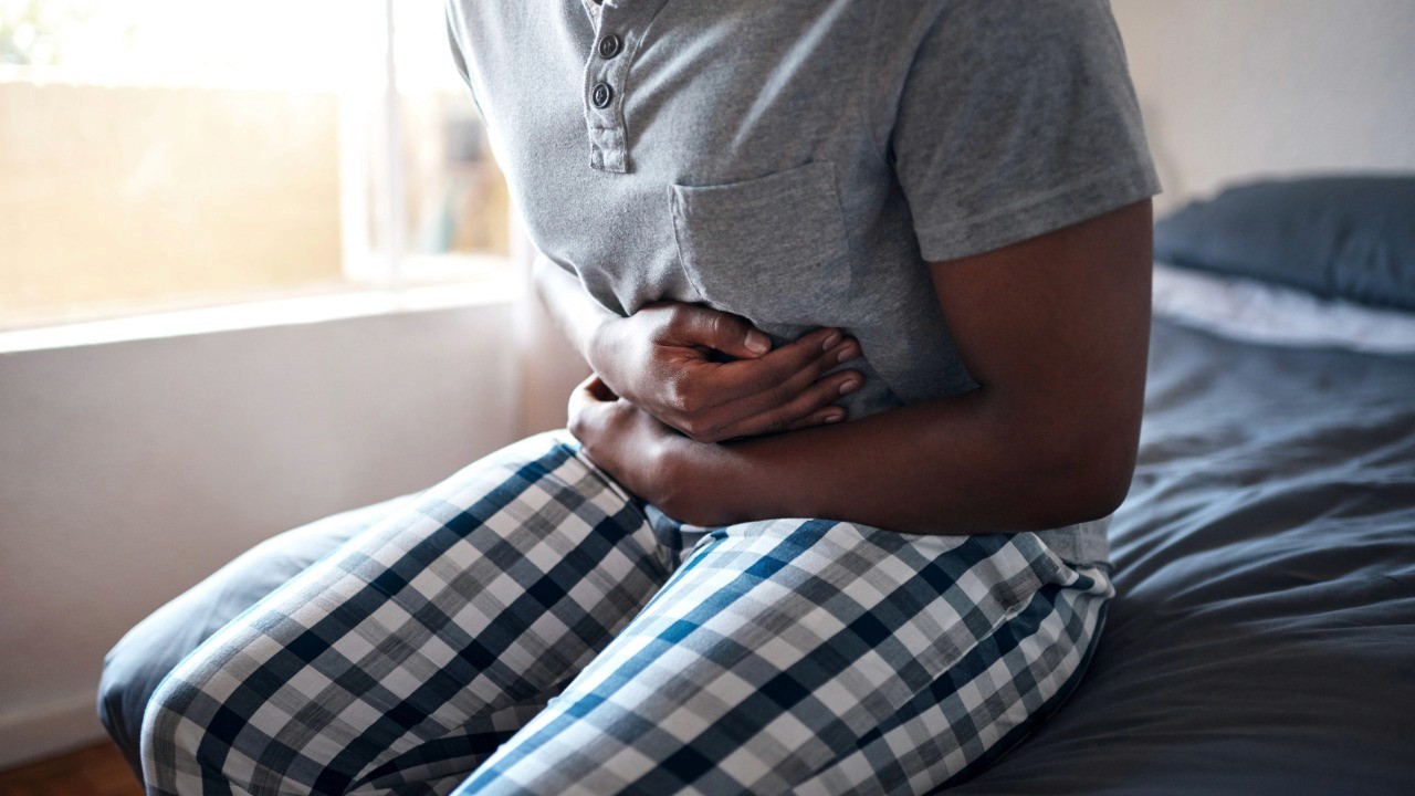 person holding their stomach in pain