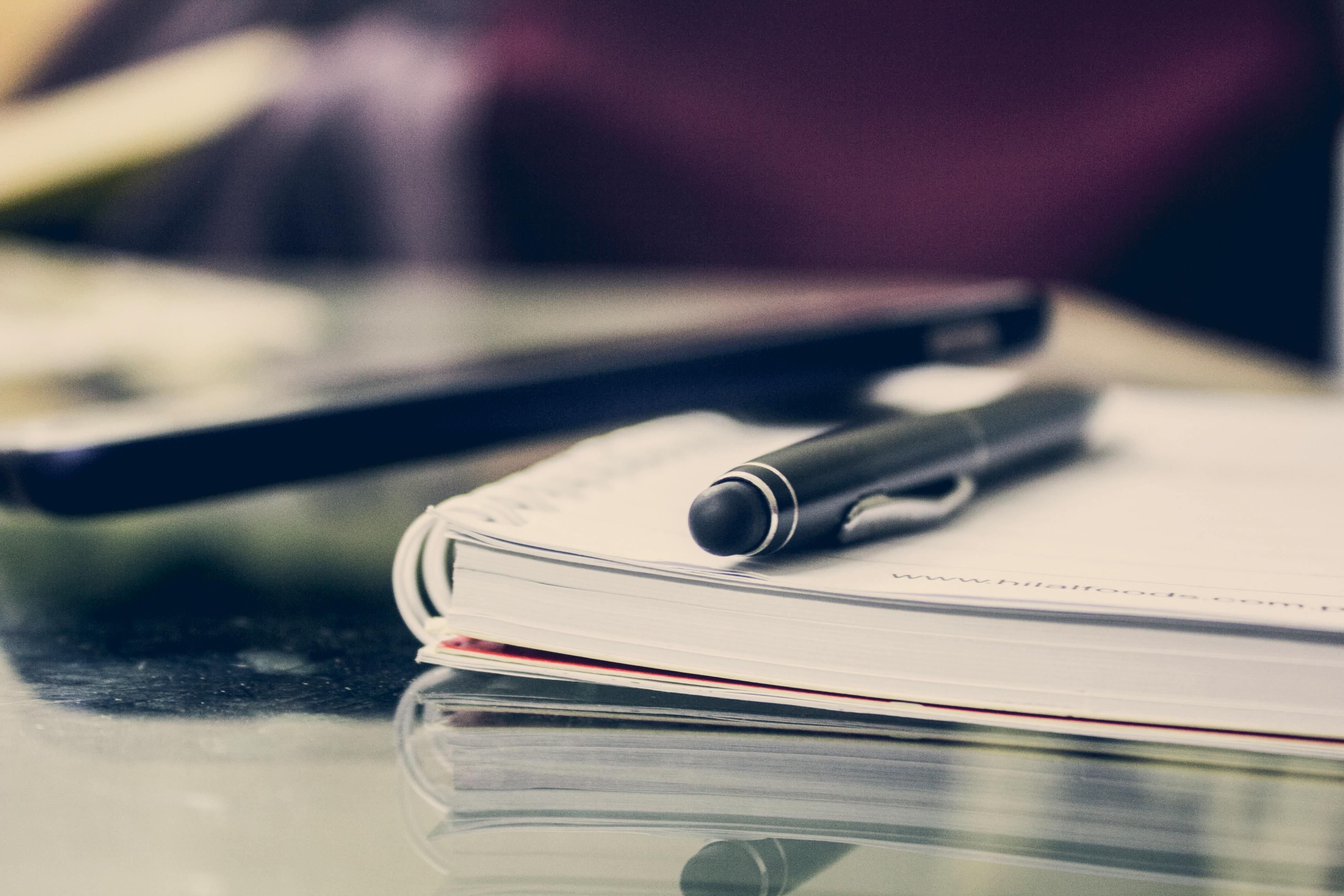 Pen resting on top of a notebook