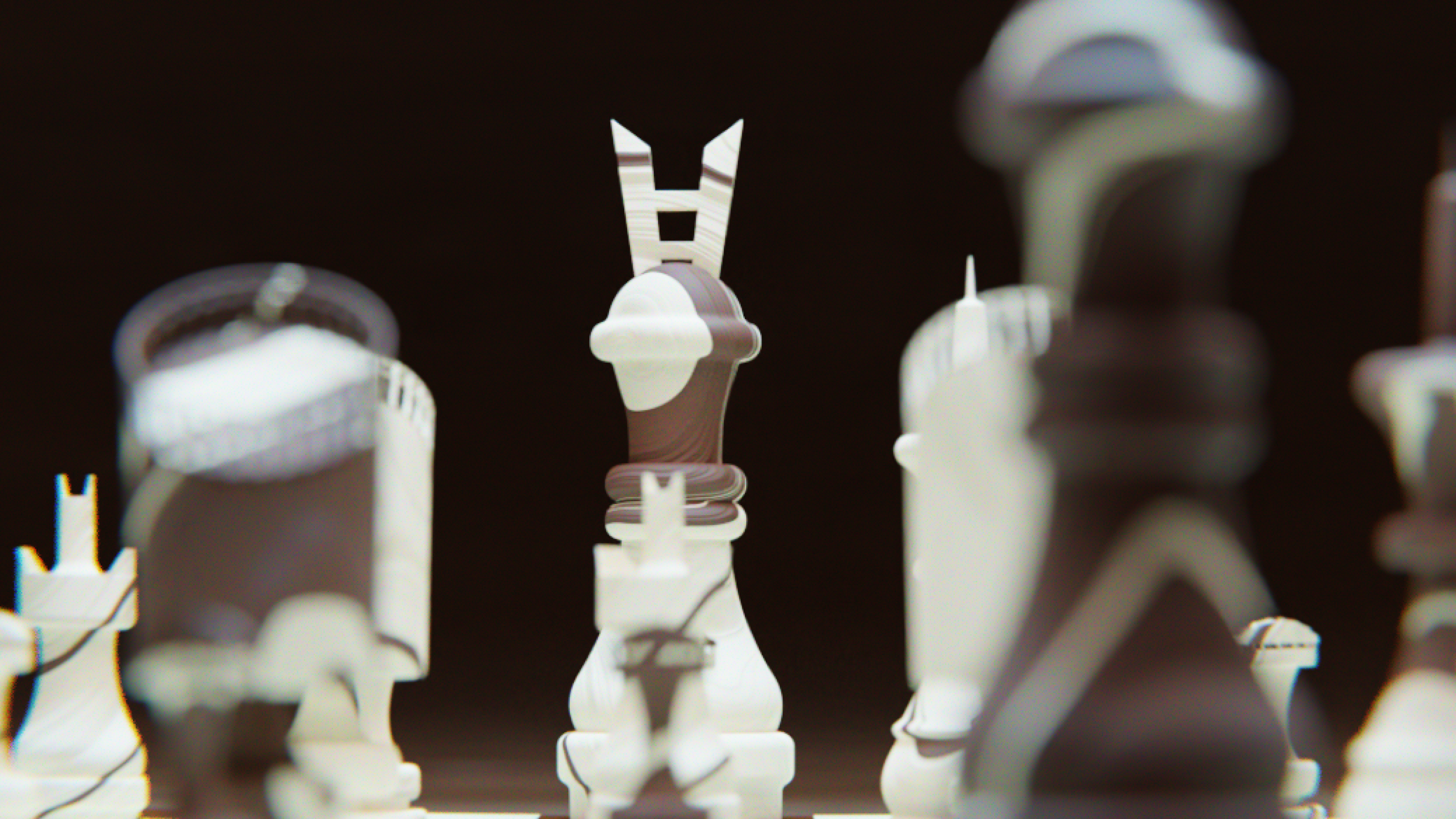 Large outdoor wall mural split vertically: a weathered pink field on the left and a pale concrete panel on the right bearing “AVANT GALLERY” in bold black at top and “Emma Carter – Reflections in Colour 5th December – 12th January” at bottom, set above a city pavement.