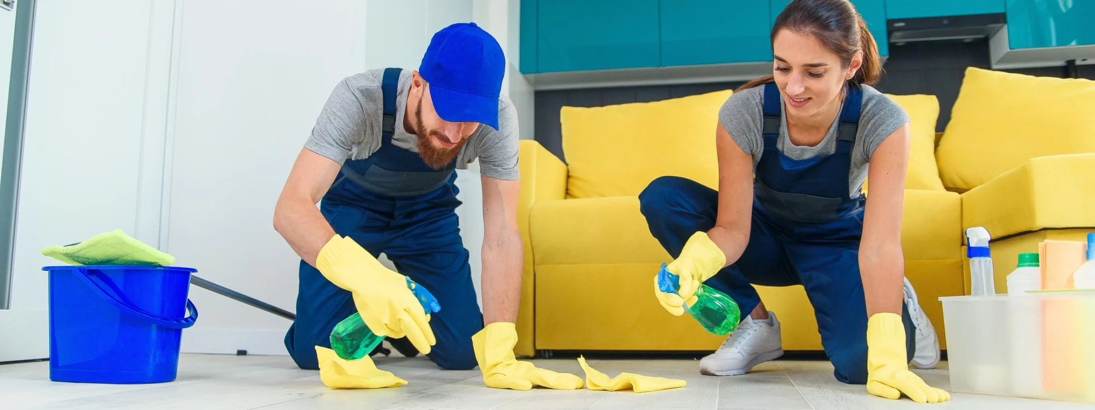 Two persons are cleaning the floor.