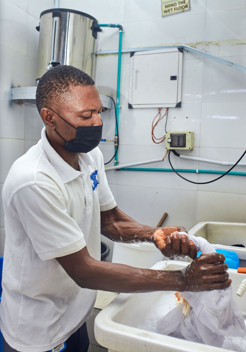 person washing hands on sink
