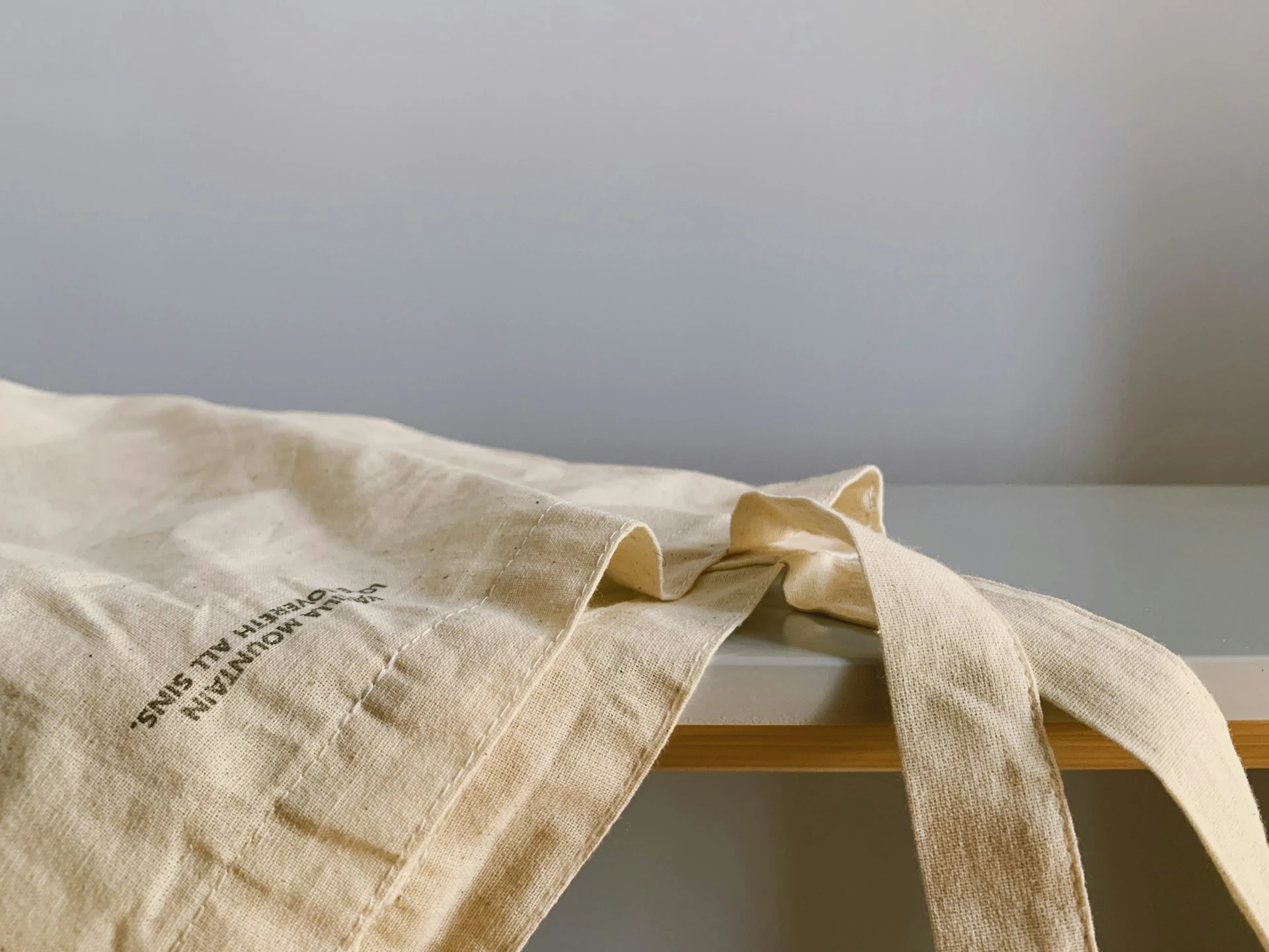 a white fabric tote bag on a table