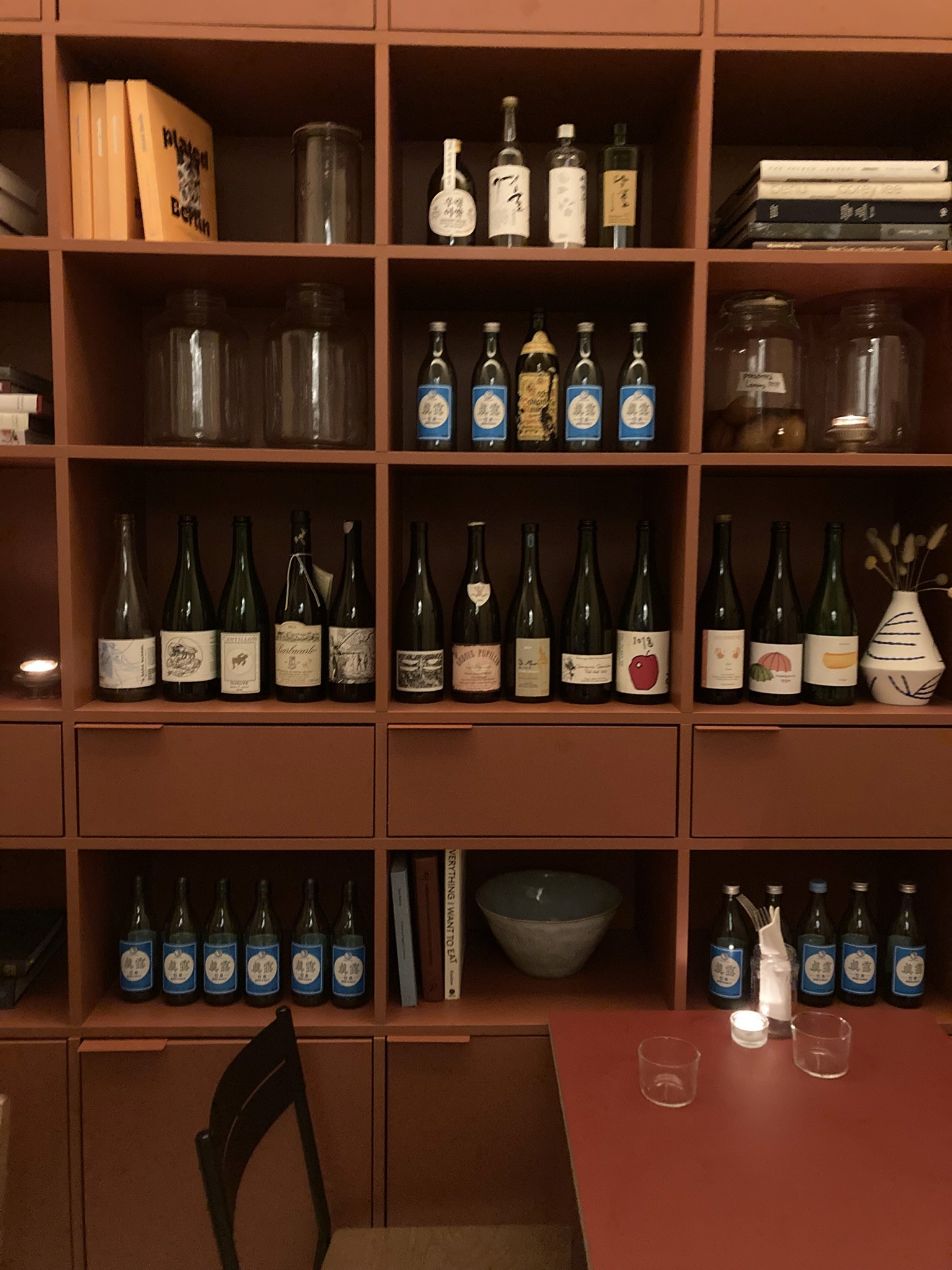 A green butterfly rests on a flower.
