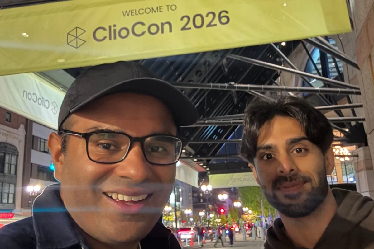 Ali and Danial from LegalMate smiling under the Welcome to ClioCon 2026 banner outside the Hynes Convention Center in Boston at night