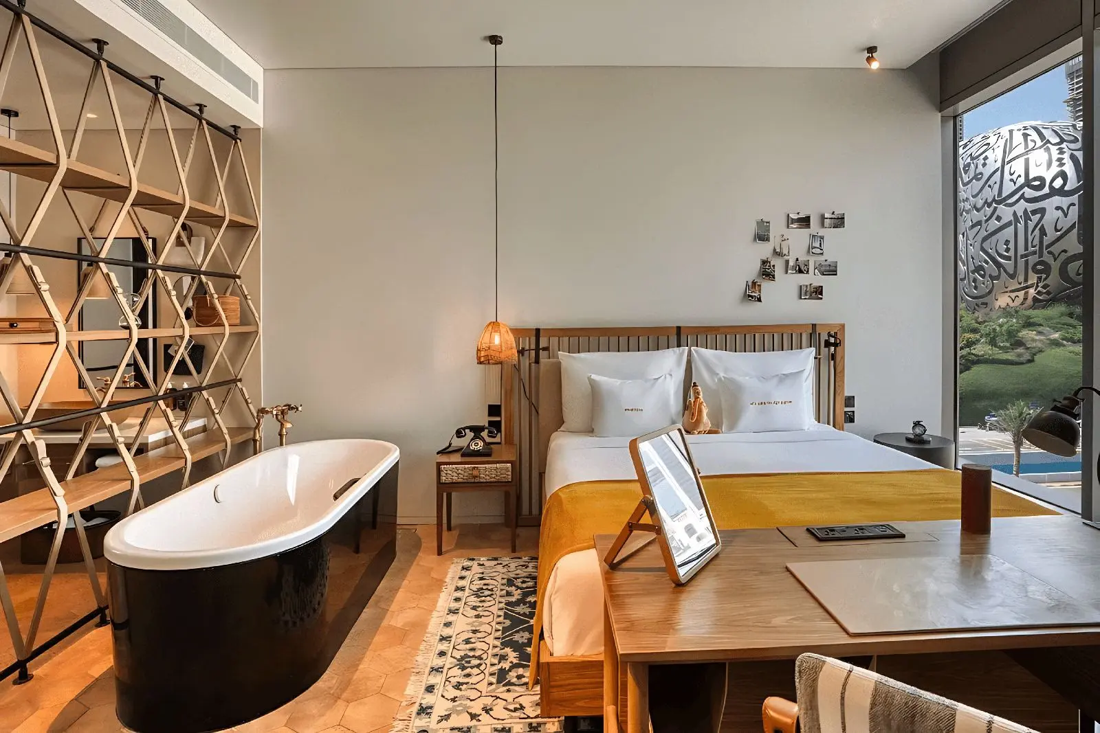 A pet-friendly hotel room in Dubai with a bed, seating area, and bathtub, representative of the city's pet-welcoming stays