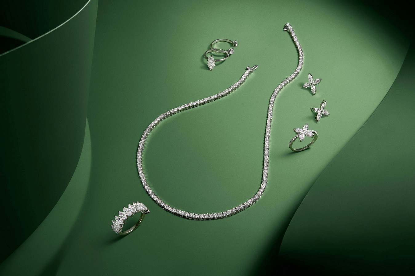 cross section of necklace and earring on green background