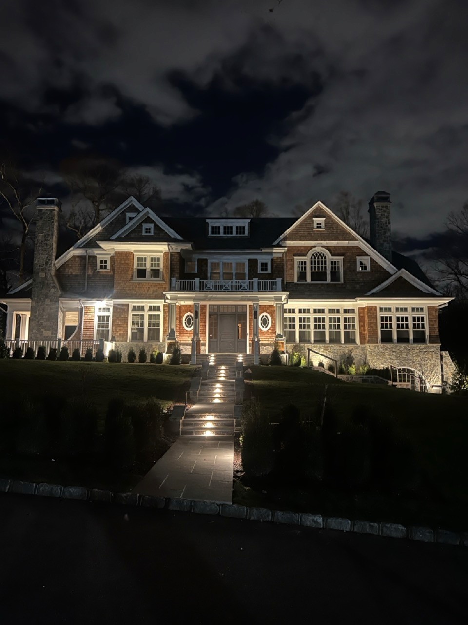 Shingle mansion with landscape lighting at night by Bonilla Irrigation & Contracting, Long Island NY