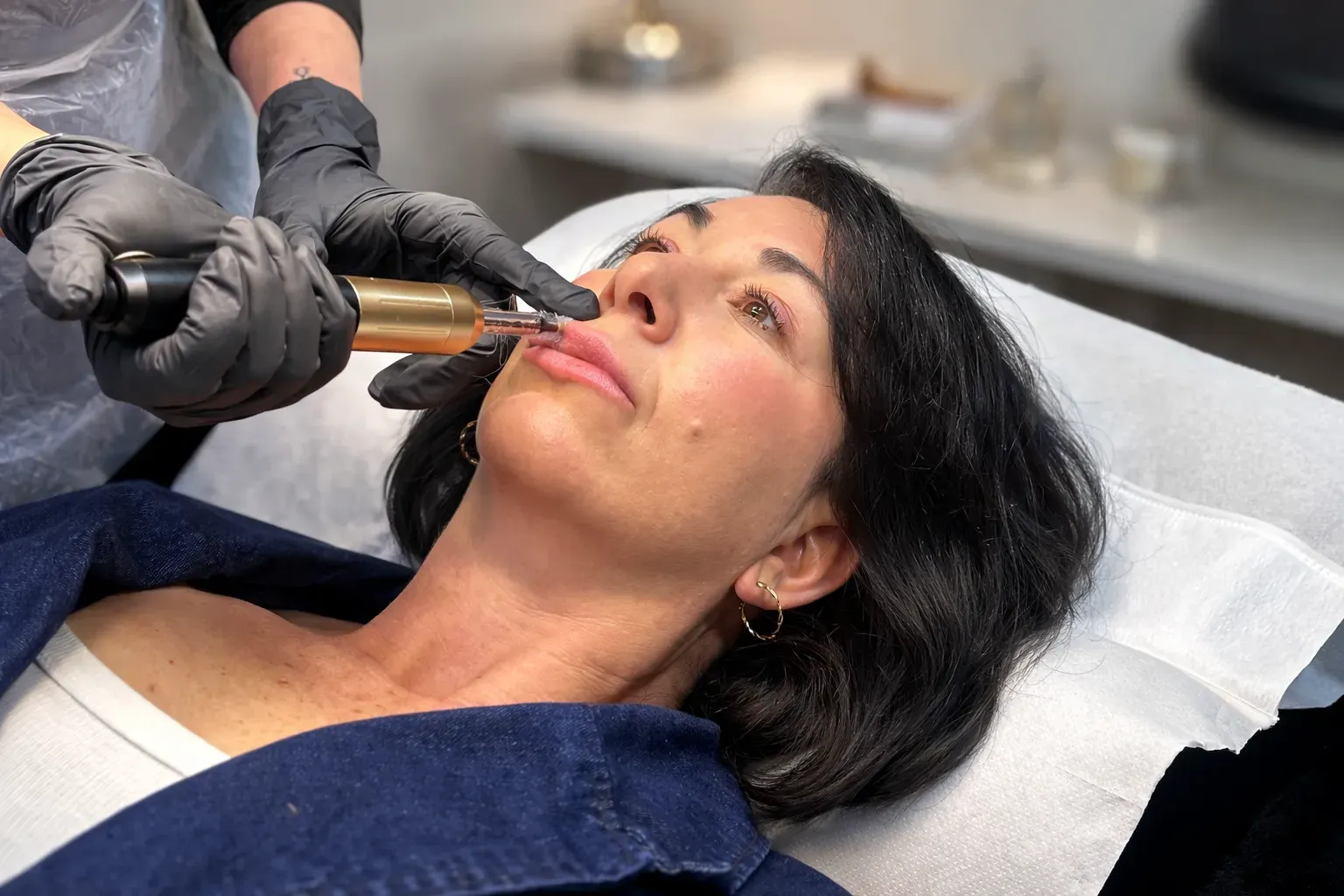 Client receiving a facial treatment using a precision device, performed by a practioner in a clincal setting