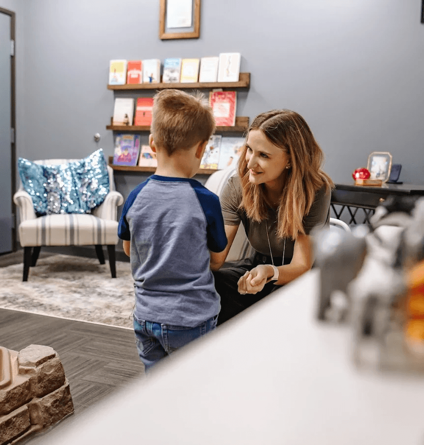 Child therapist in Dallas working with a young child during a counseling session at WellNest Counseling