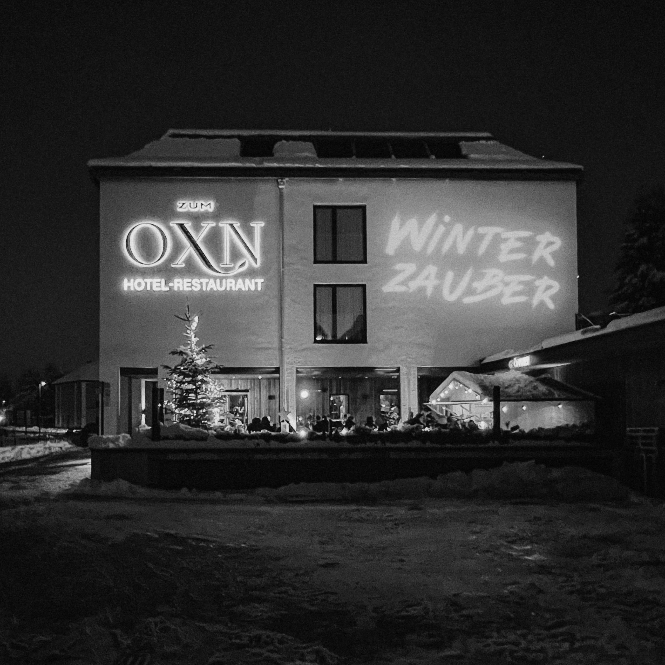 A building at night with illuminated signage for "Media Studio" and "Film City."