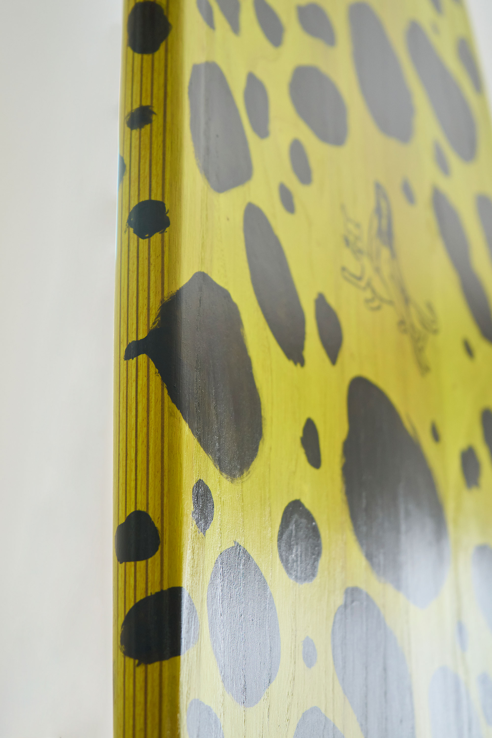 Painted bottom and rail of a timber surfboard