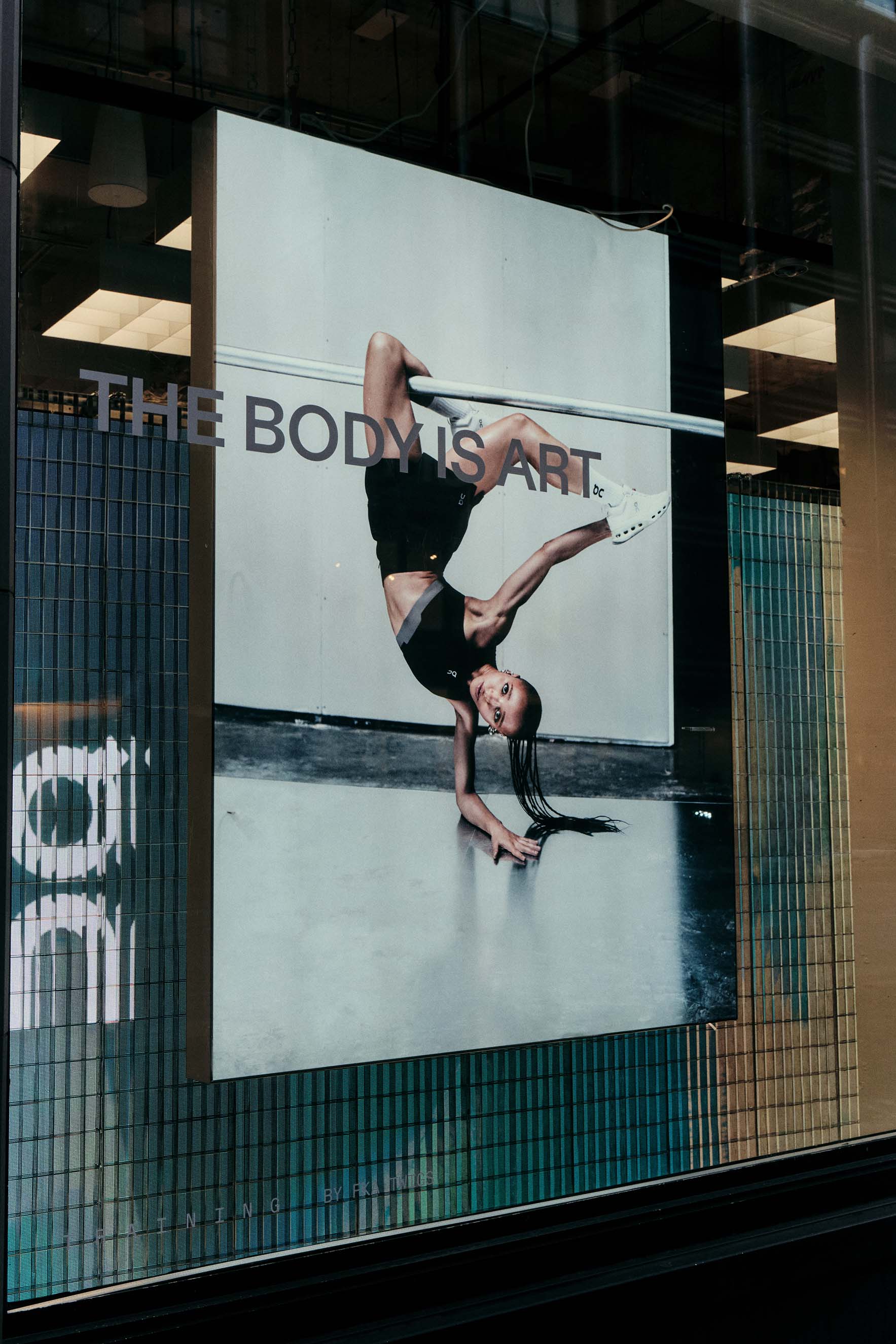 Elegant typographic window vinyl quote by FKA twigs for the On campaign branding, applied to a retail glass door to communicate brand strategy through minimalist graphic design and high-end visuals.