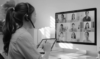 Blurred profile of a person in a dark cap and jacket, set against a black background, creating a mysterious and dynamic composition.