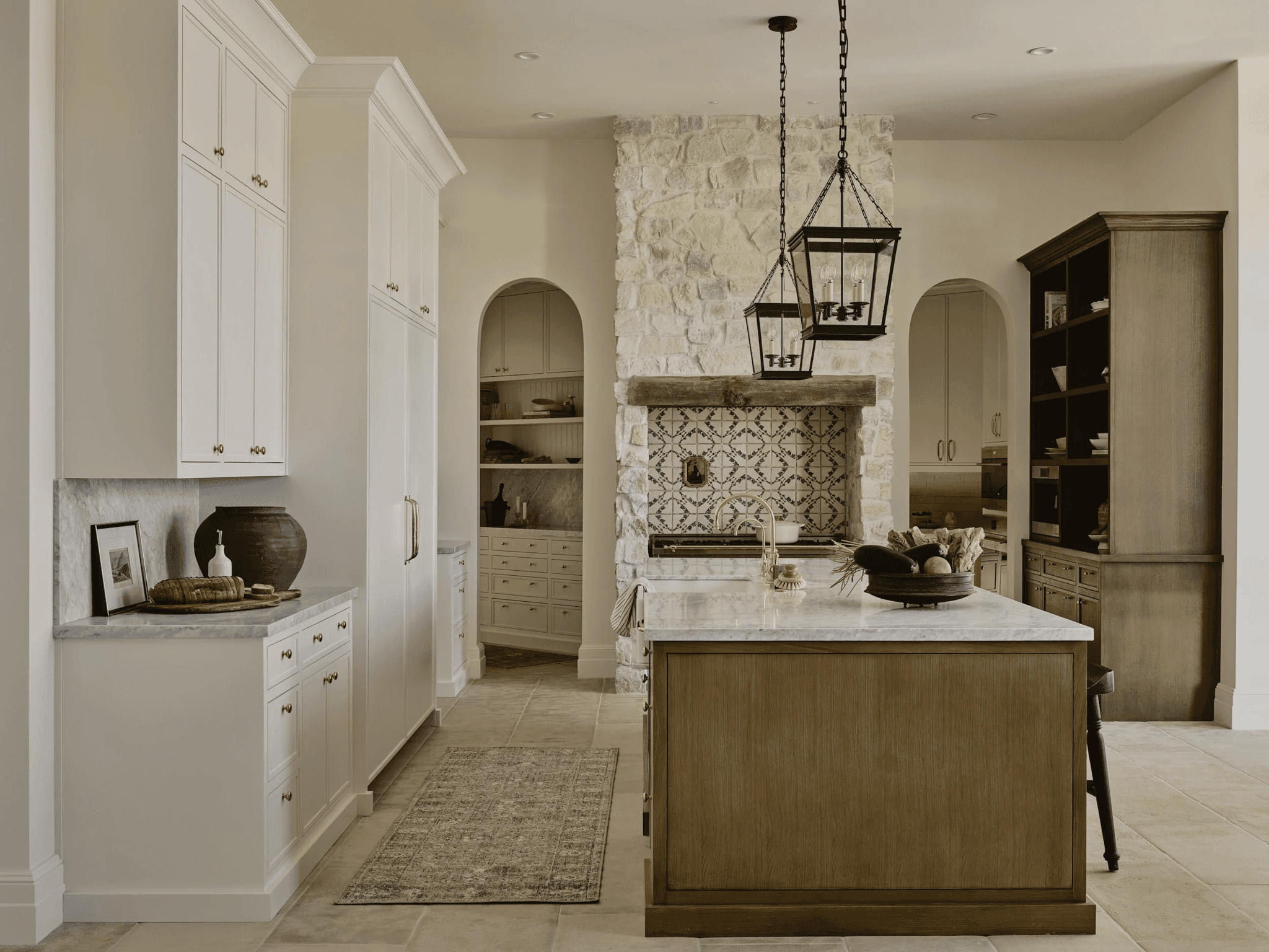Rift white oak island with painted perimeter cabinetry under a stone range hood, Paradise Valley