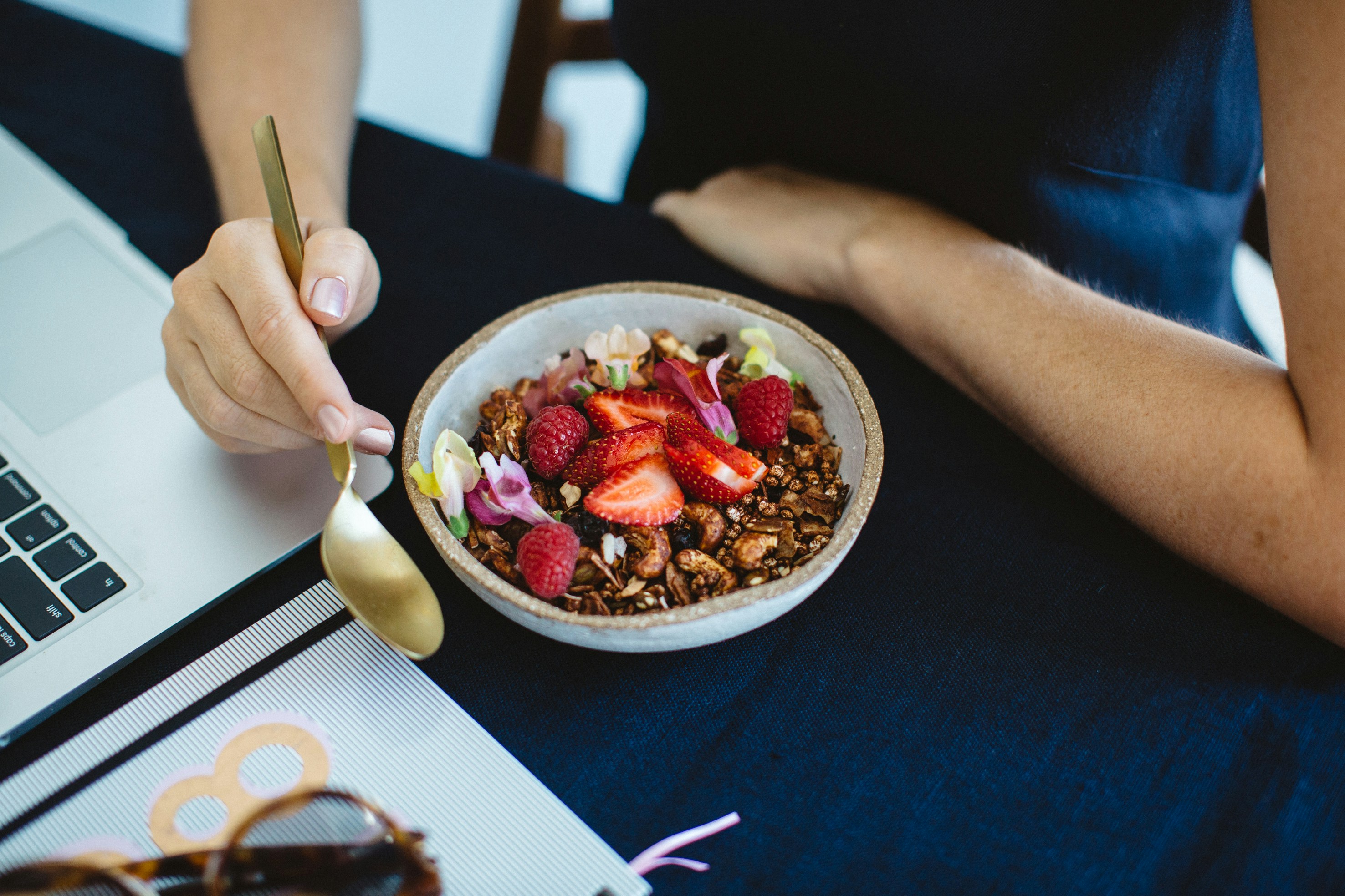 Bowl of granola topped with fresh fruit, an example of a balanced breakfast with protein, fiber, and calcium.