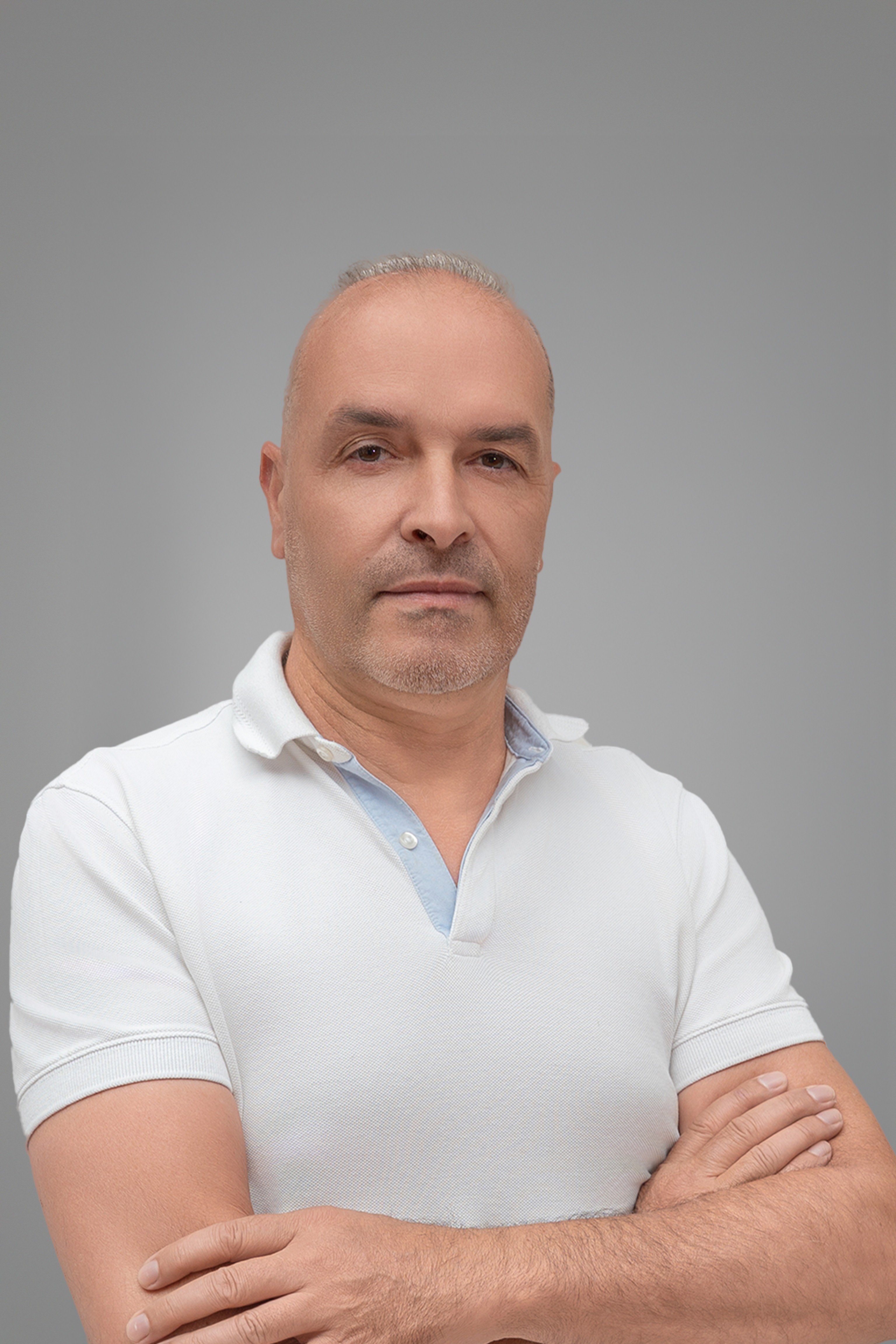 A wooden cube teeters on the edge of a rectangular block against a plain background.