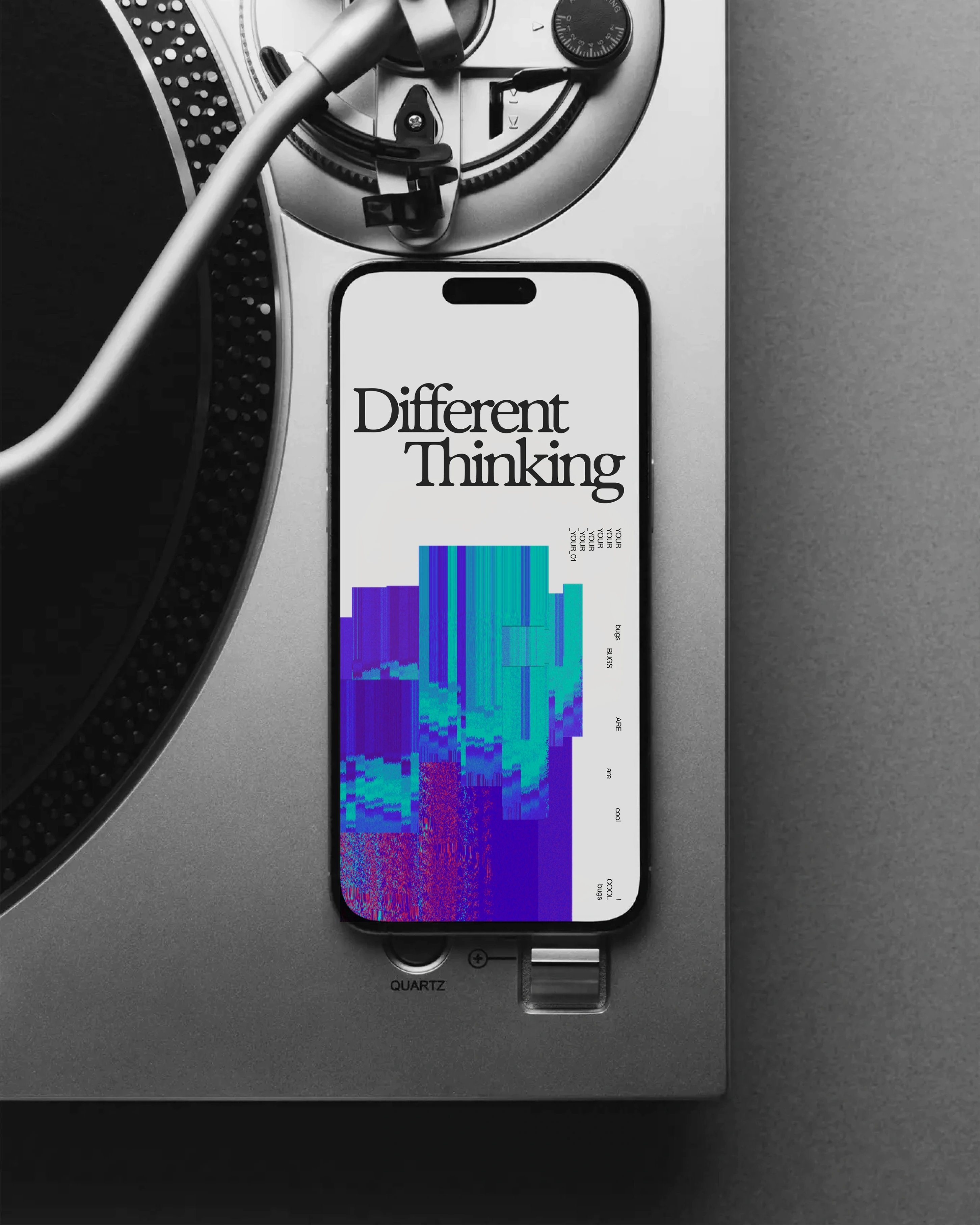 Phone on a turntable displaying the Different Thinking logo and glitch artwork