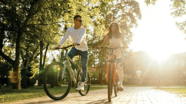 <img src="your-image.jpg" alt="A men and women cycling through shades of forest road." />
