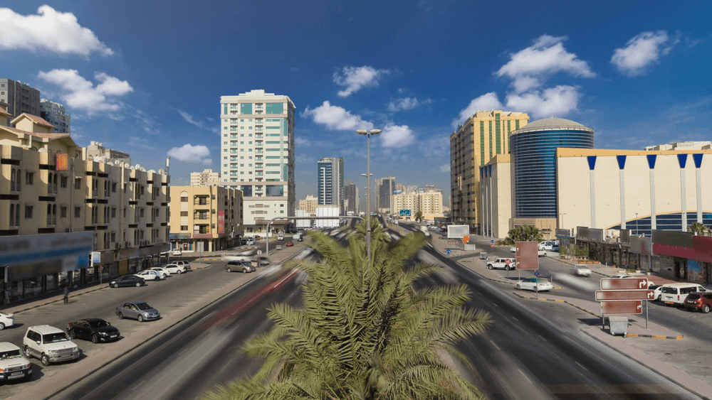 A wide view of the busy streets and commercial buildings surrounding Ajman Free Zone, a prime location for business licenses.