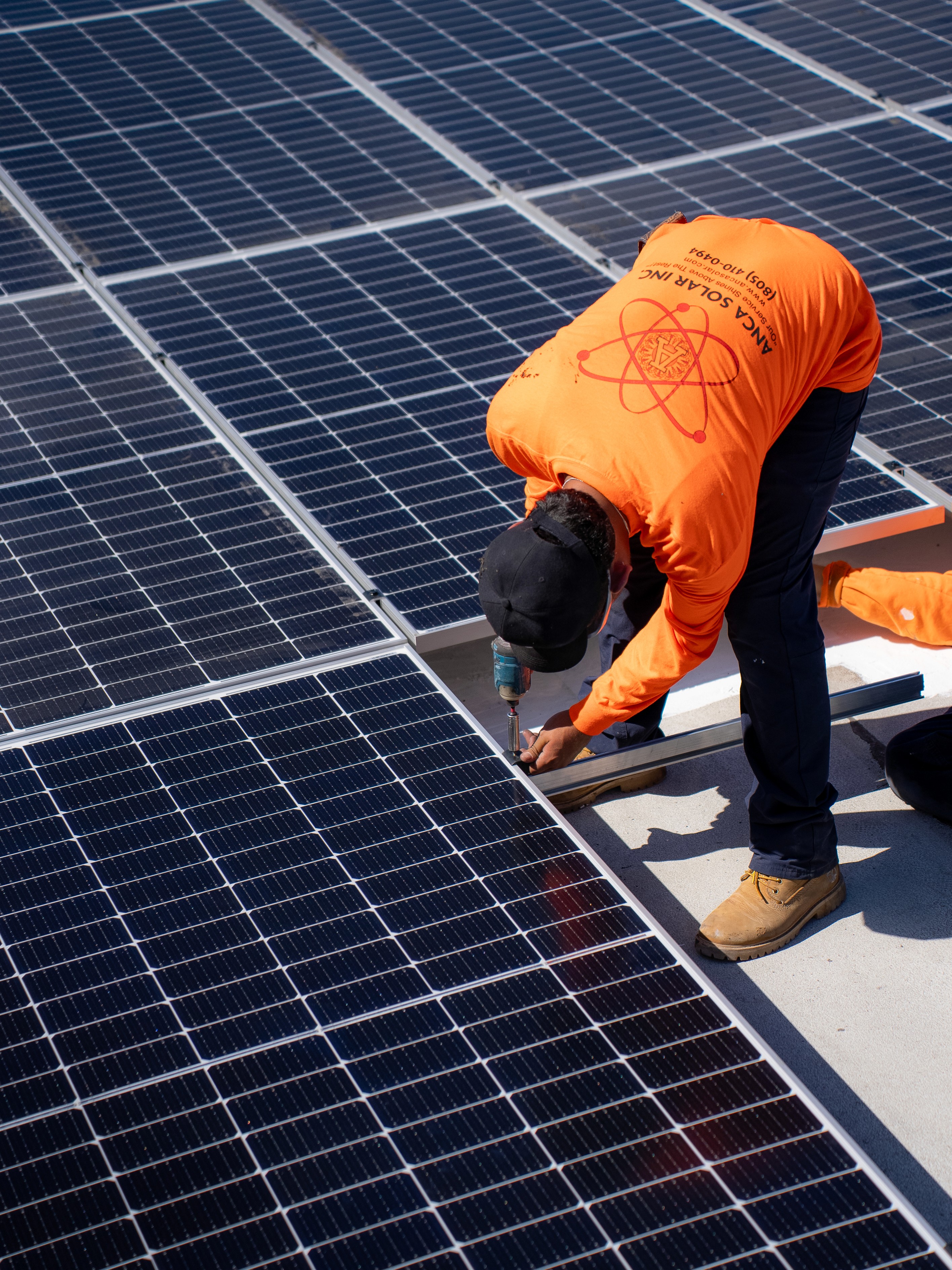 Anca Solar installer mounting solar panels on residential rooftop Los Angeles