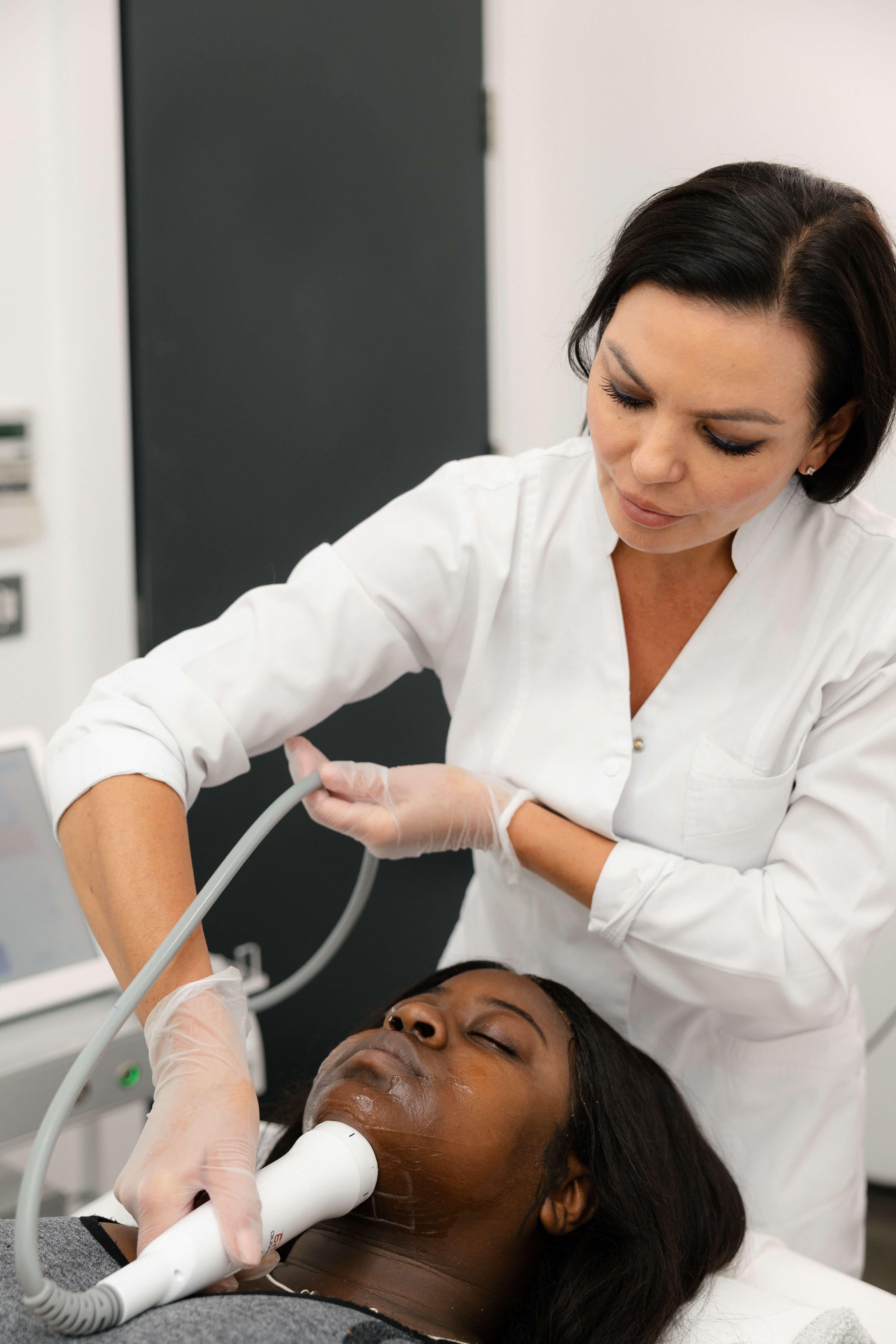 Aesthetic practitioner performing a professional facial treatment on a client at SIGMA Skin Clinic.