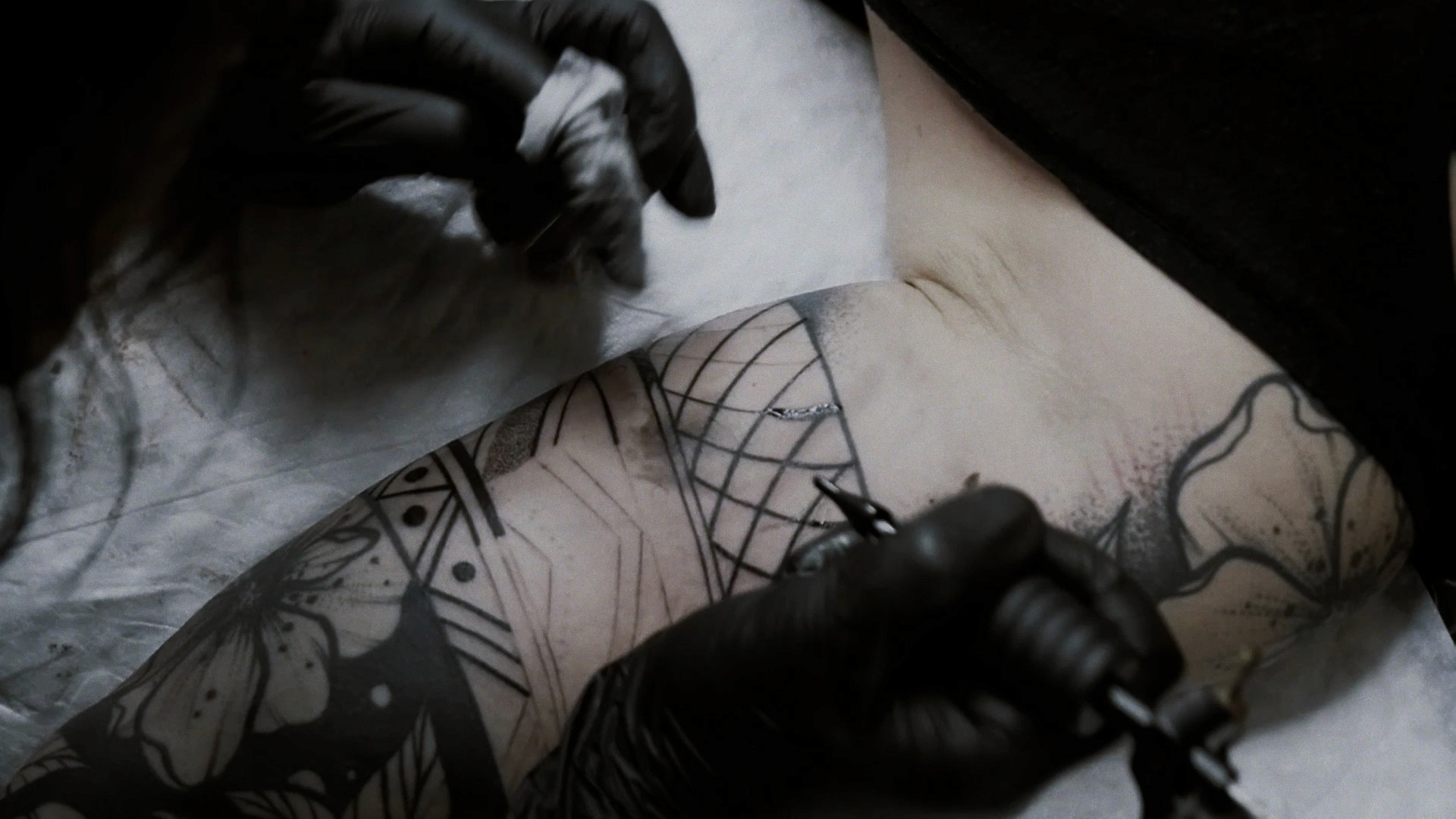 Cinematic art film from above of Yanina Viland working on a tattoo
