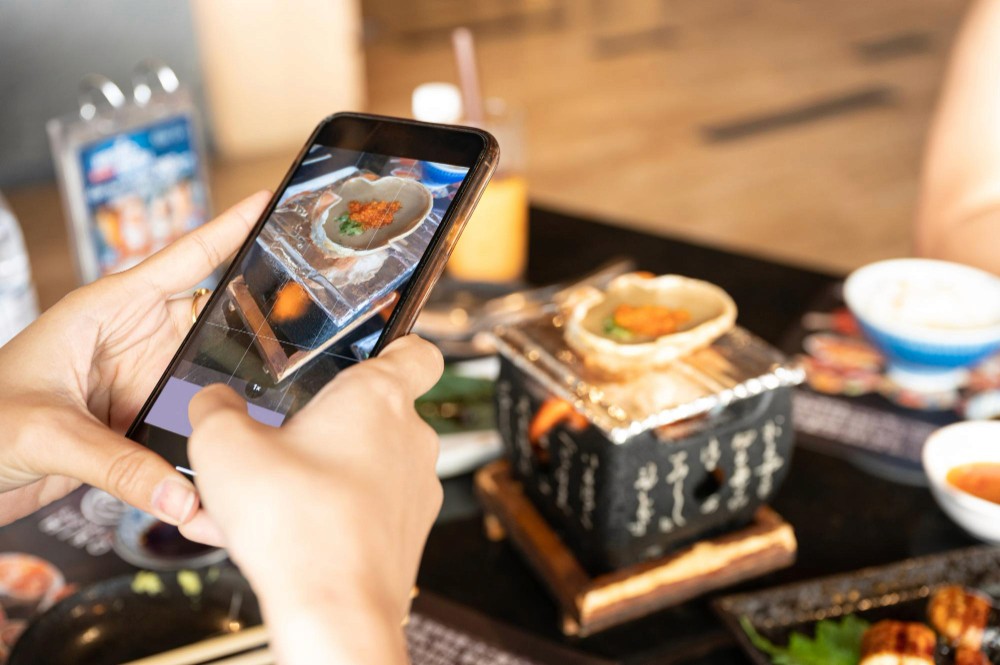 person-taking-food-image-on-camera-freepik