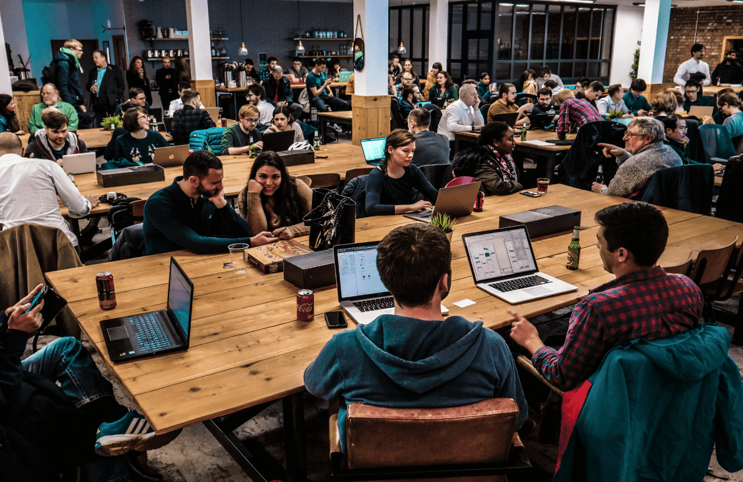 People sitting and watching a person writing on a project.
