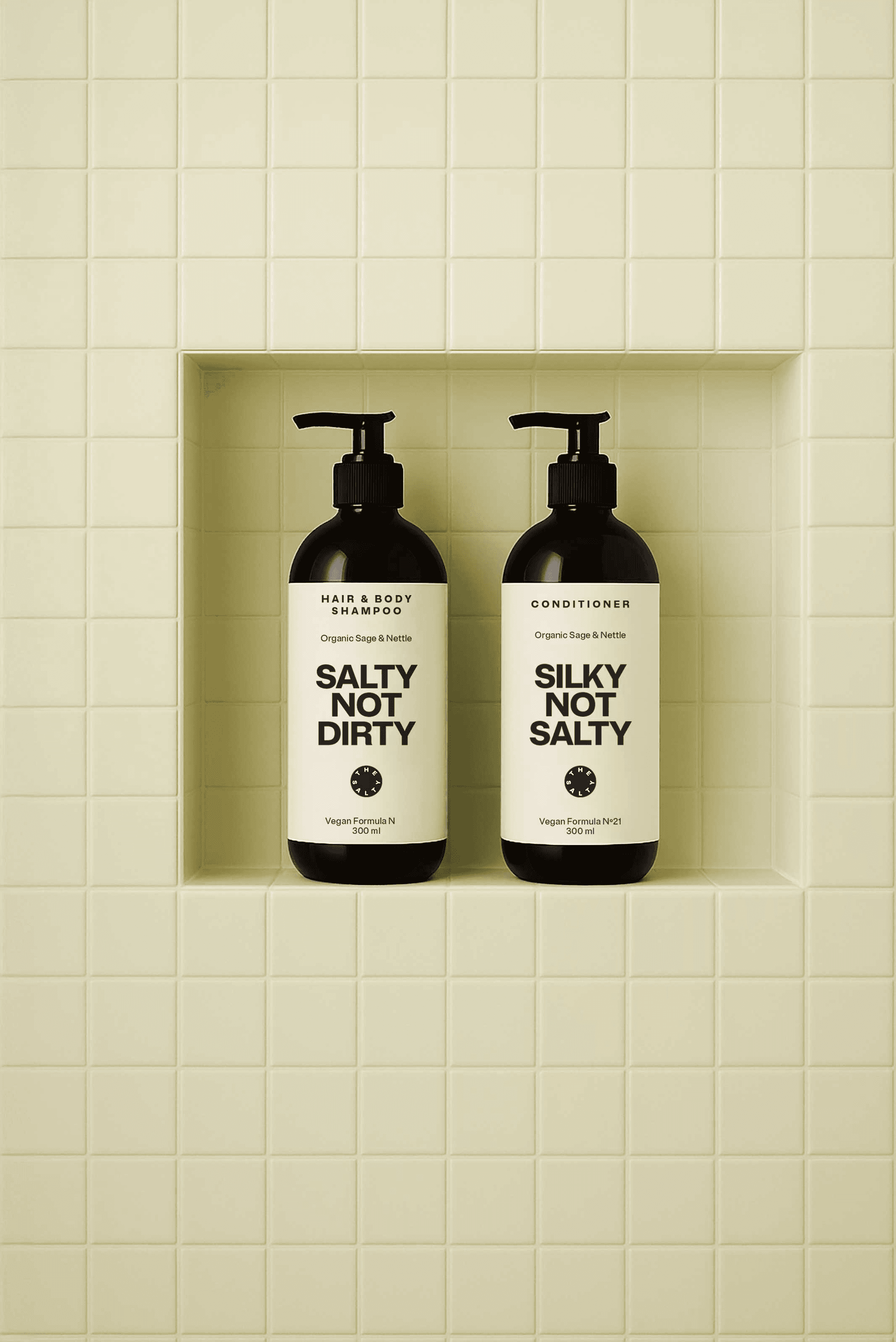 Shampoo and conditioner bottles labeled with The Salty branding and short quotes.