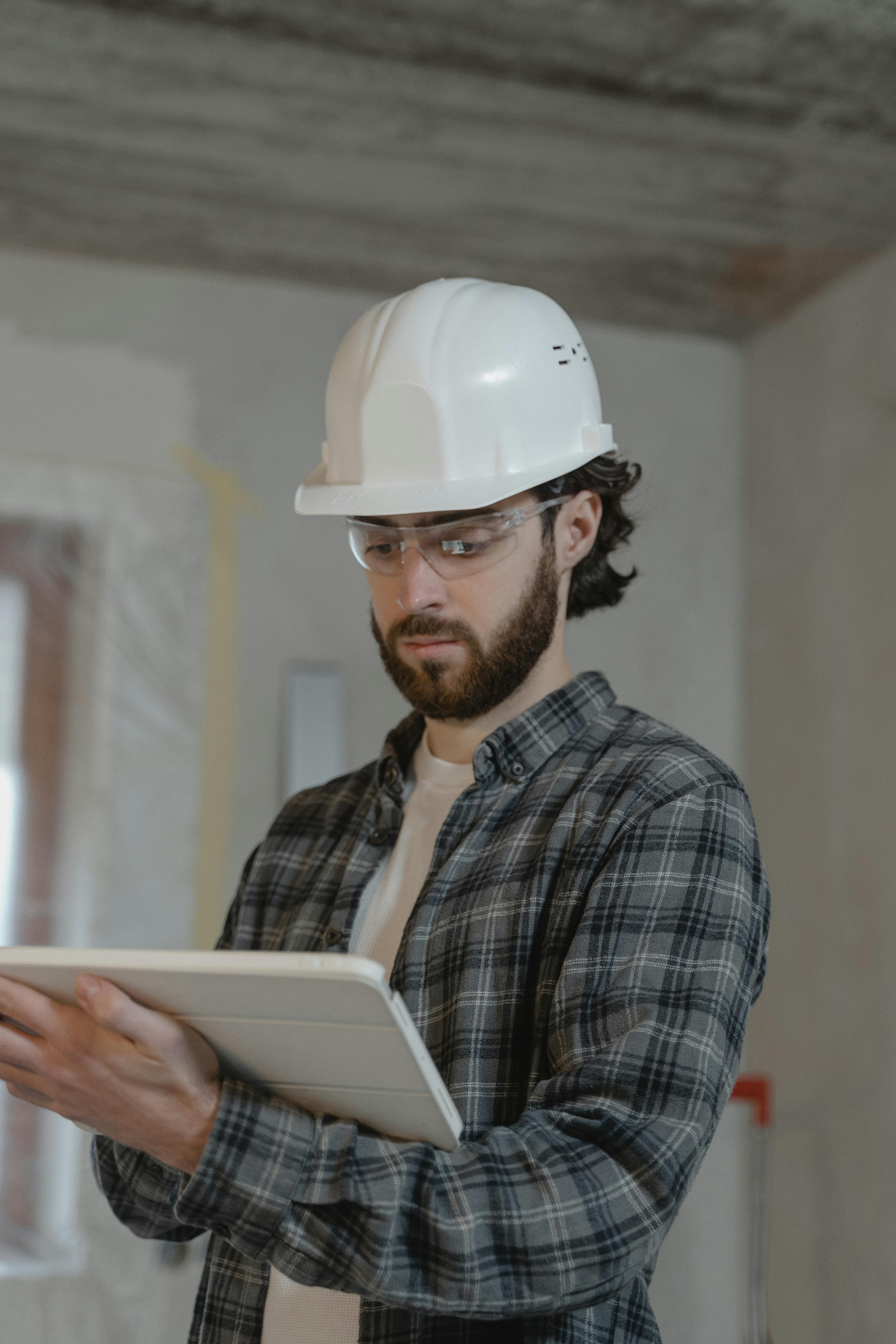 a man wearing a red hard hat and jacket