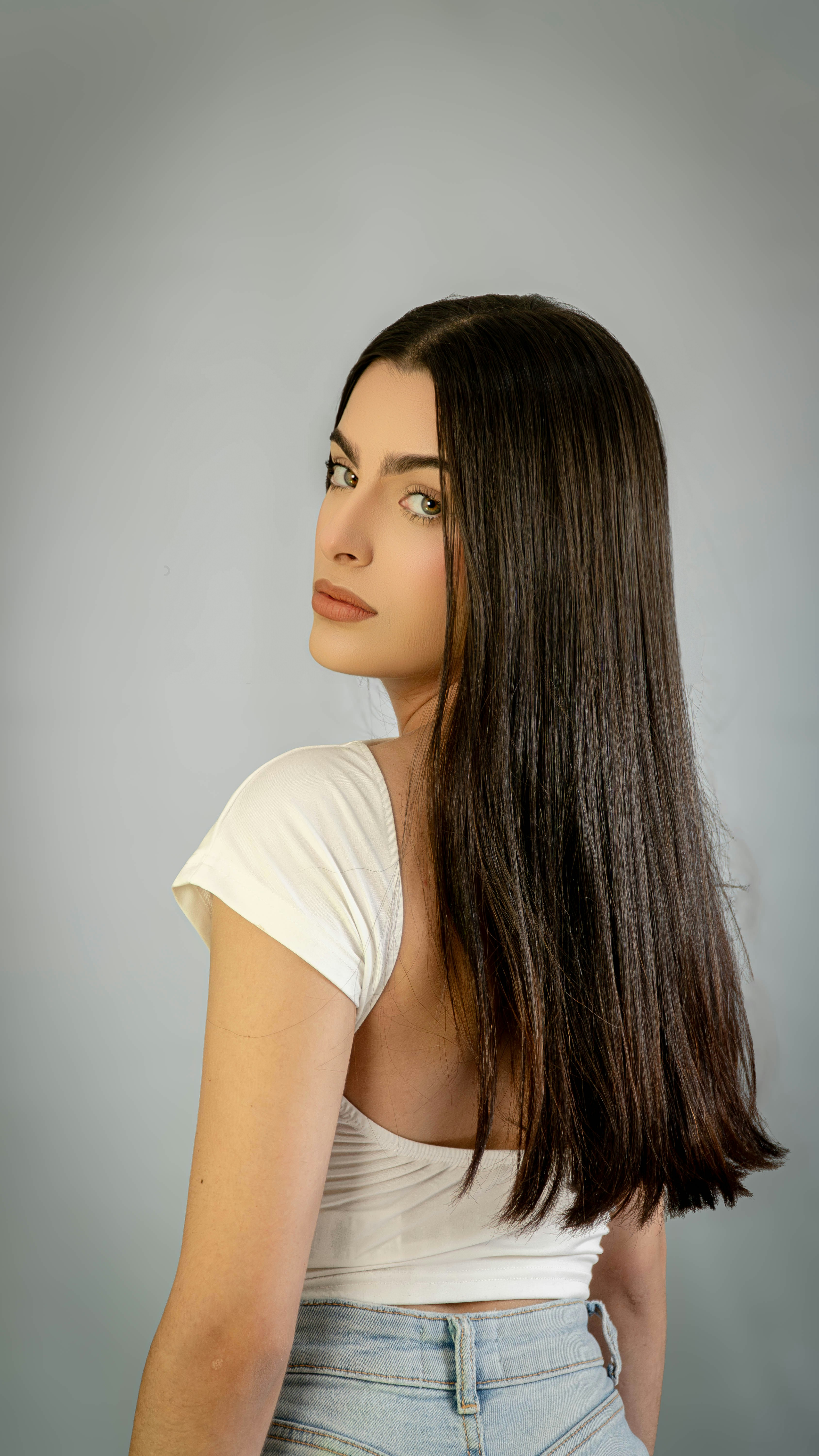 A woman with long hair and a white shirt