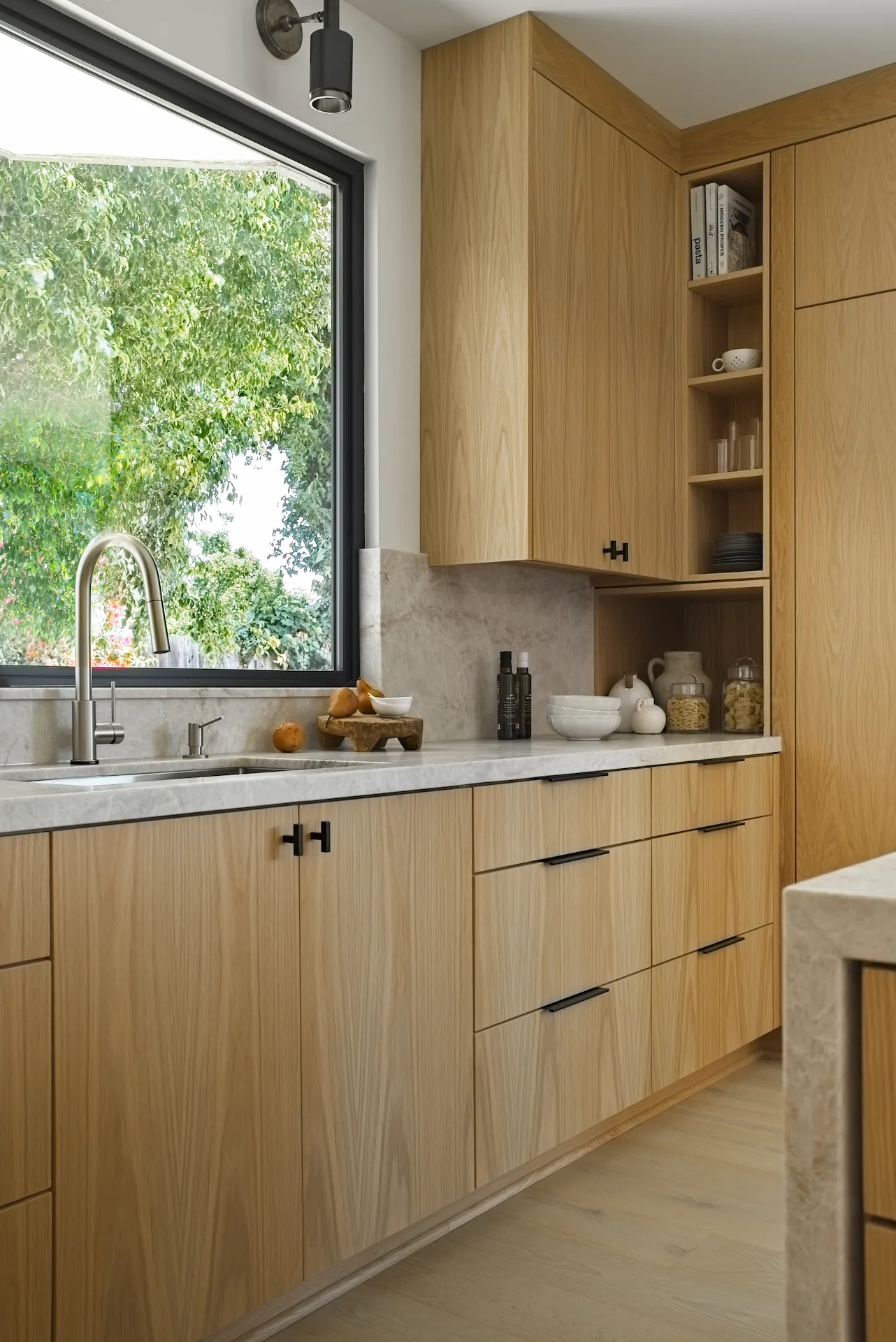 Portrait view of the modern faucet and sink area in the Fullerton kitchen remodel. Photo by Todd Huge.