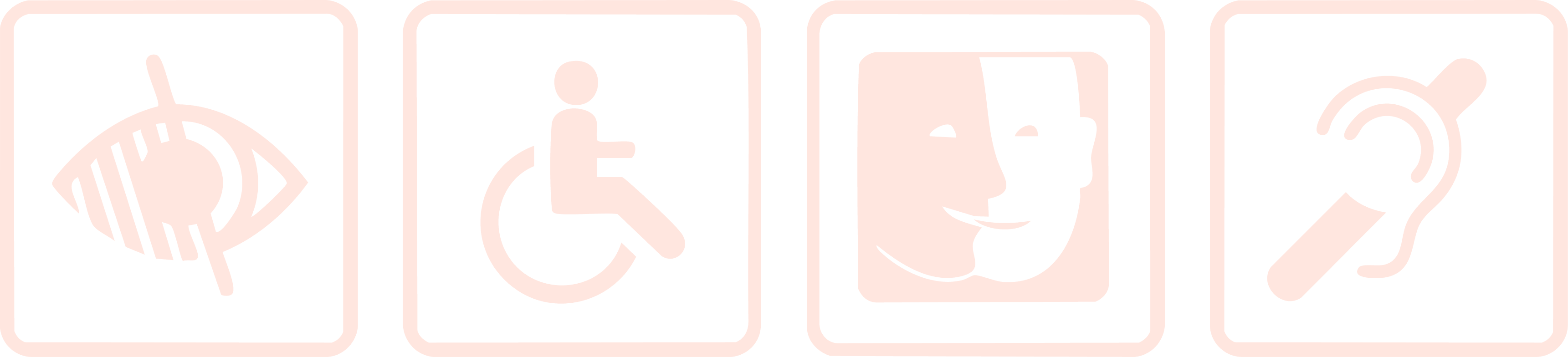 Man in a dark sweater and woman in glasses wearing a navy blouse, sitting together at a desk with a laptop and smiling.