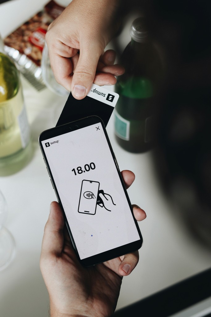 A person holding a smart phone in their hand