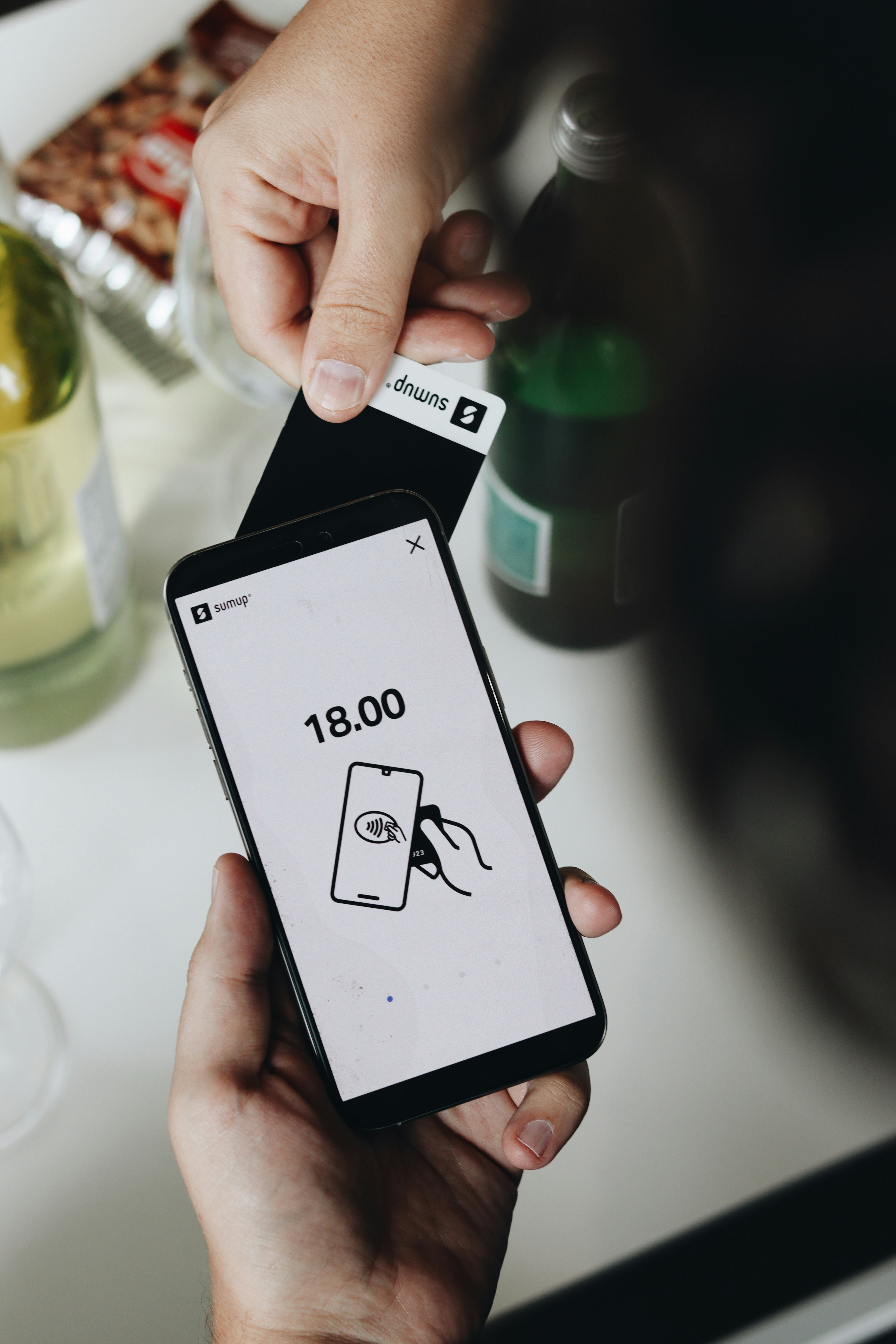 A person holding a smart phone in their hand