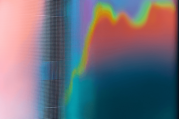 Three people sitting on a couch in a room looking at mobile devices