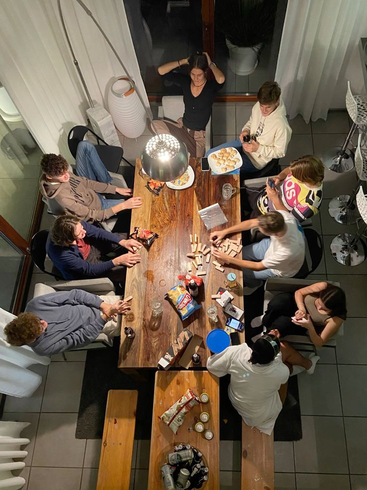 a woman sitting at a table with a bowl of popcorn