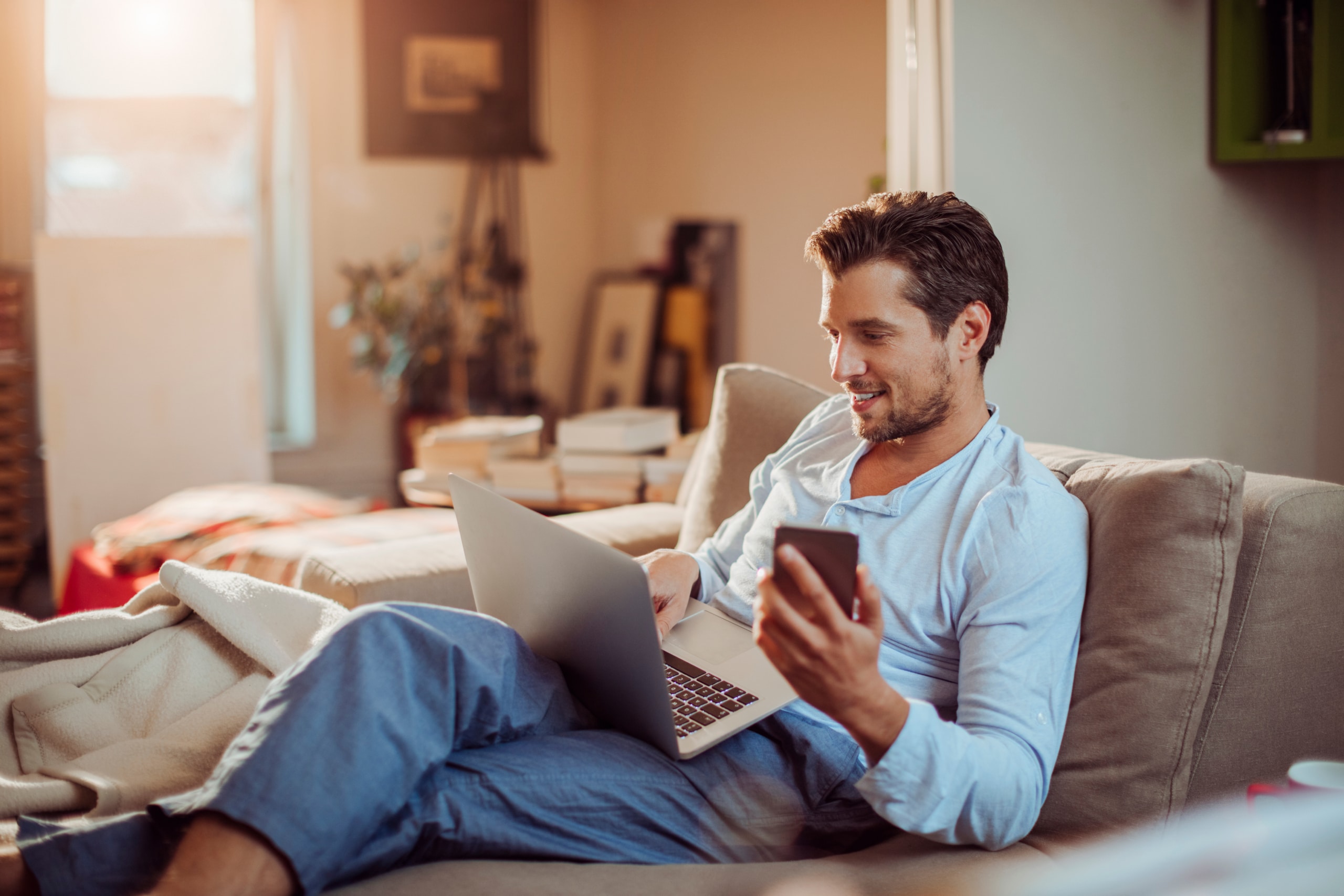 Young man using a smart phone in the morning at home