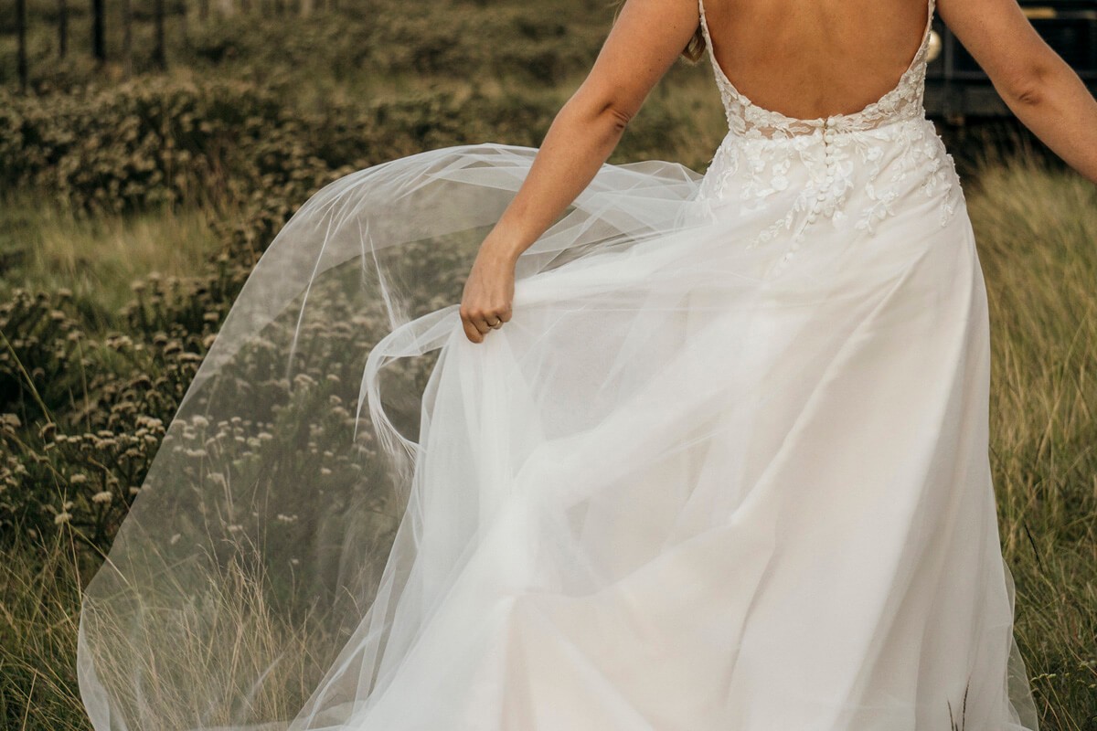Bride walking with dress flowing during romantic wedding portrait
