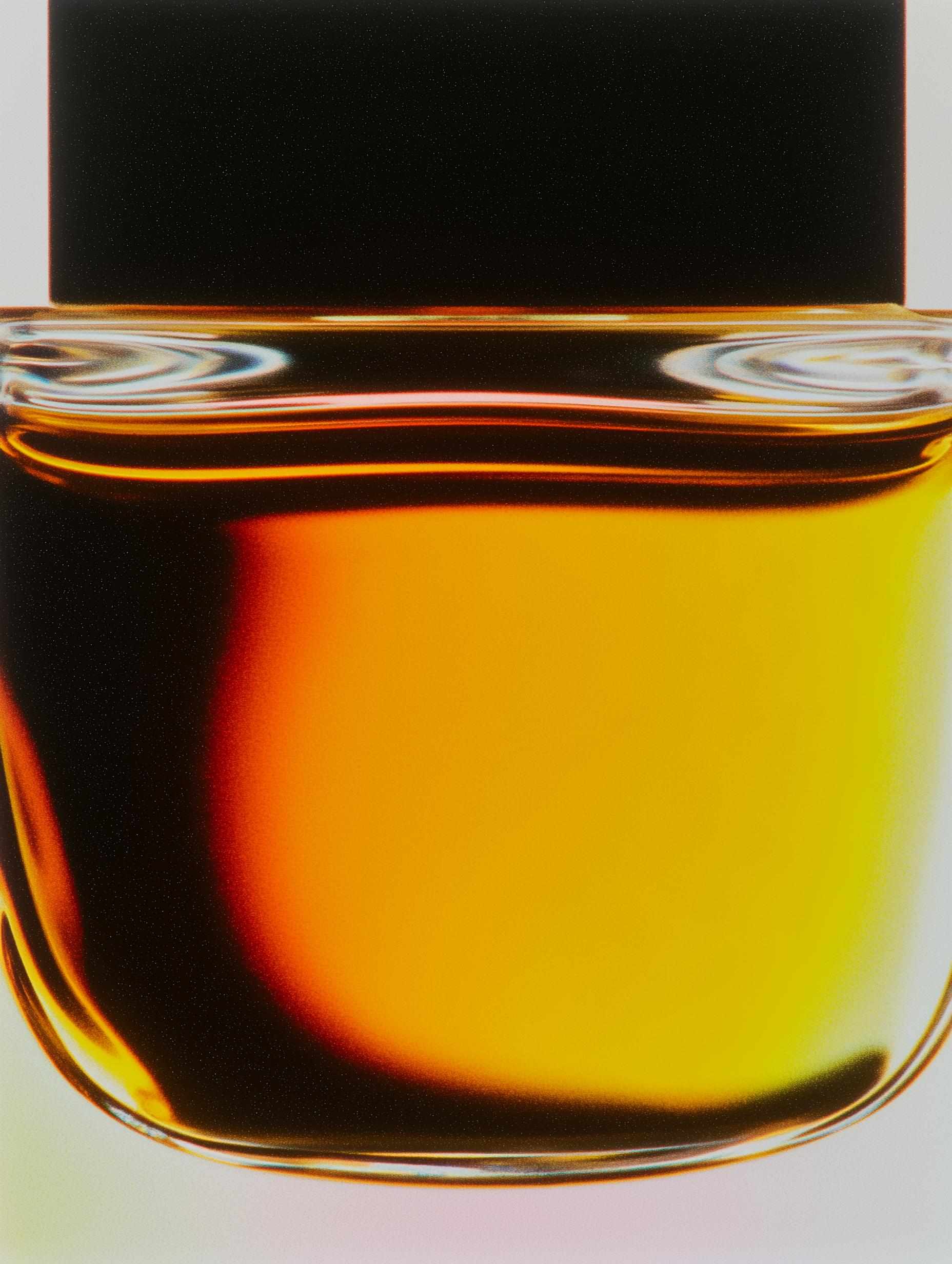 Golden amber liquid with backlight in clear glass vessel