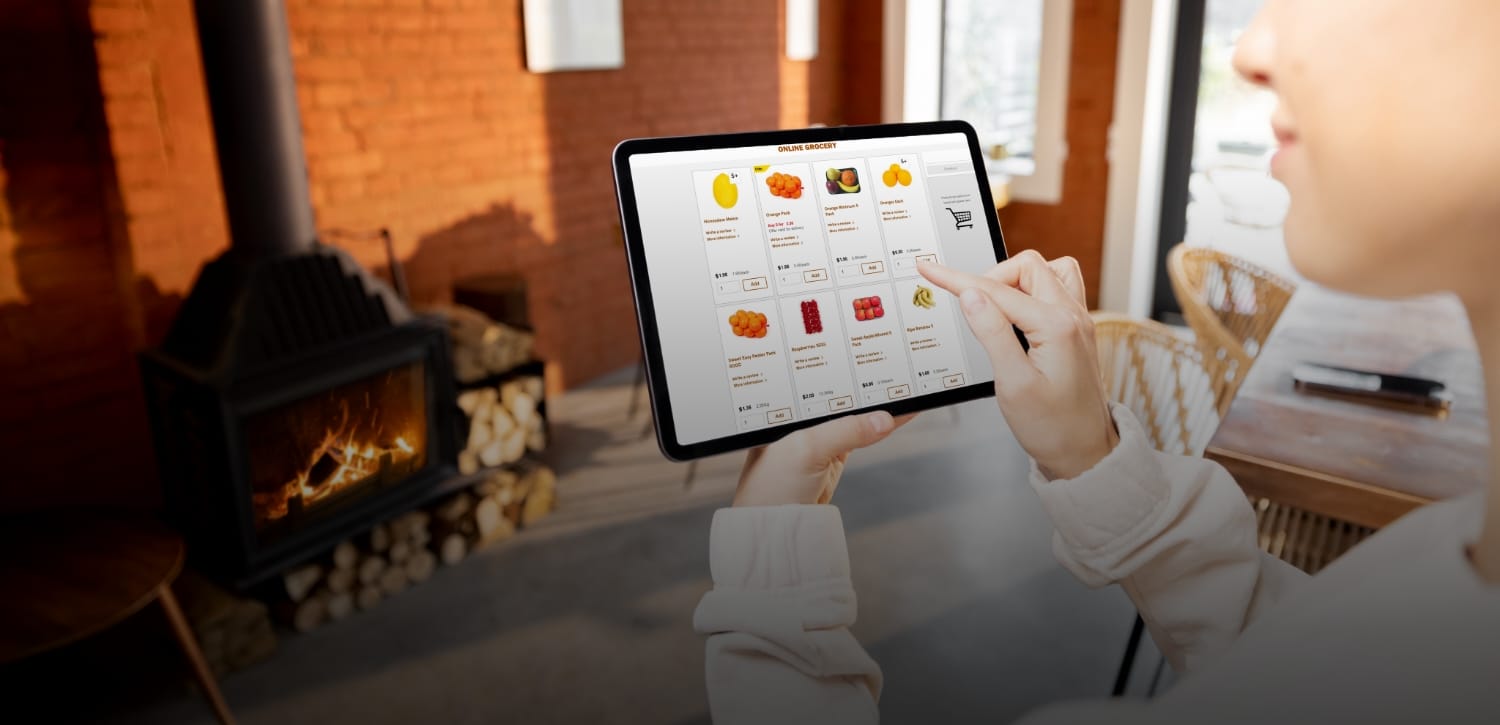A man pulls a cleaning cart near a building.