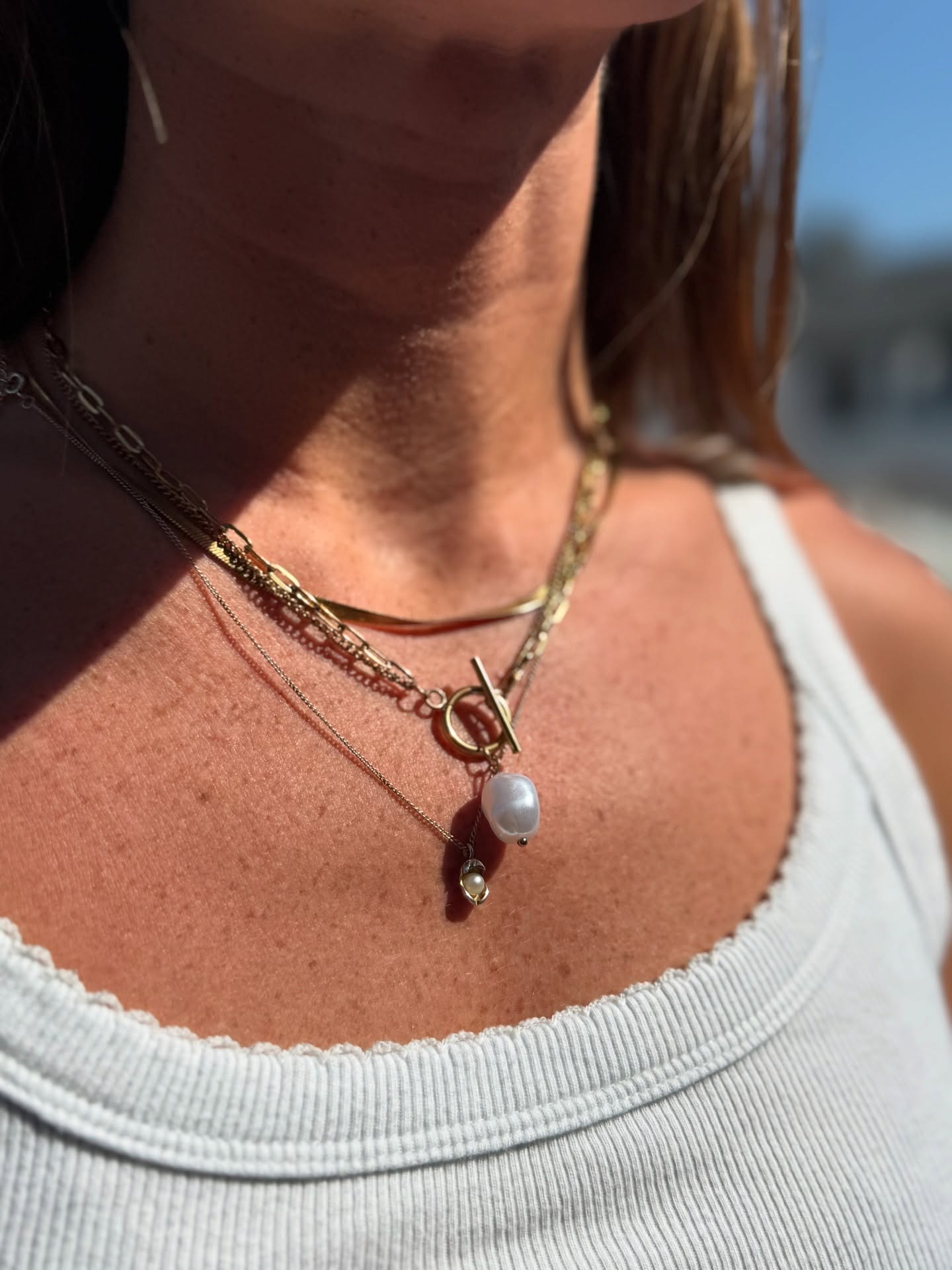 Angled view of a black athletic sneaker lying on its side, showcasing its textured, high-traction sole design against a neutral background.