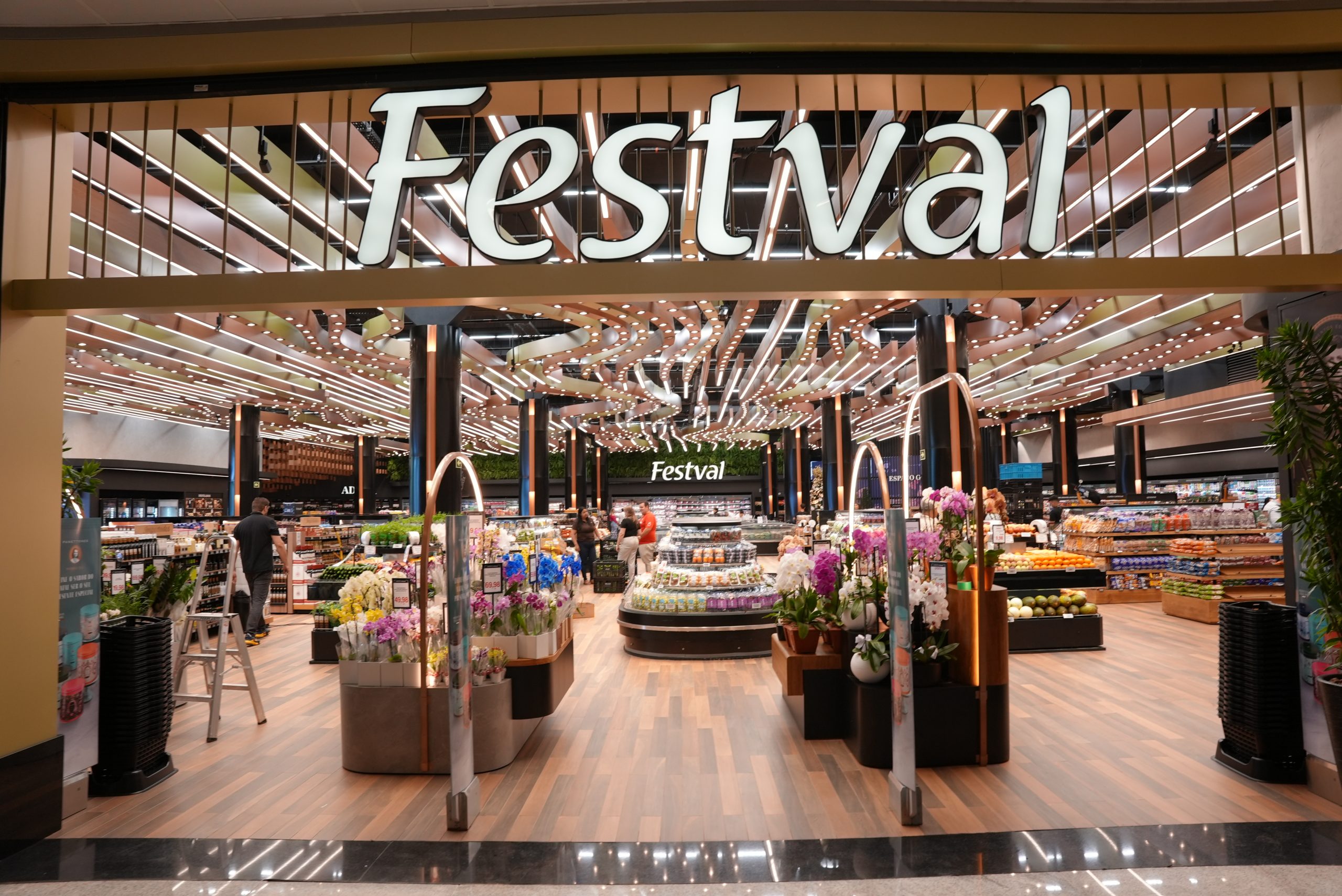 Computer monitor displaying code and data analytics, with keyboard and mouse on desk.