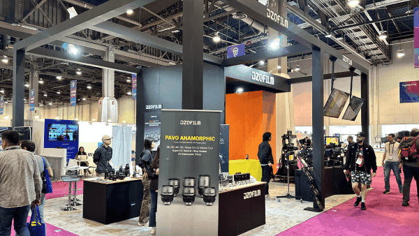 DZOFILM NAB Show large AV visibility booth with broadcast demo counters, camera display area, screen-led presentation, and open visitor viewing flow